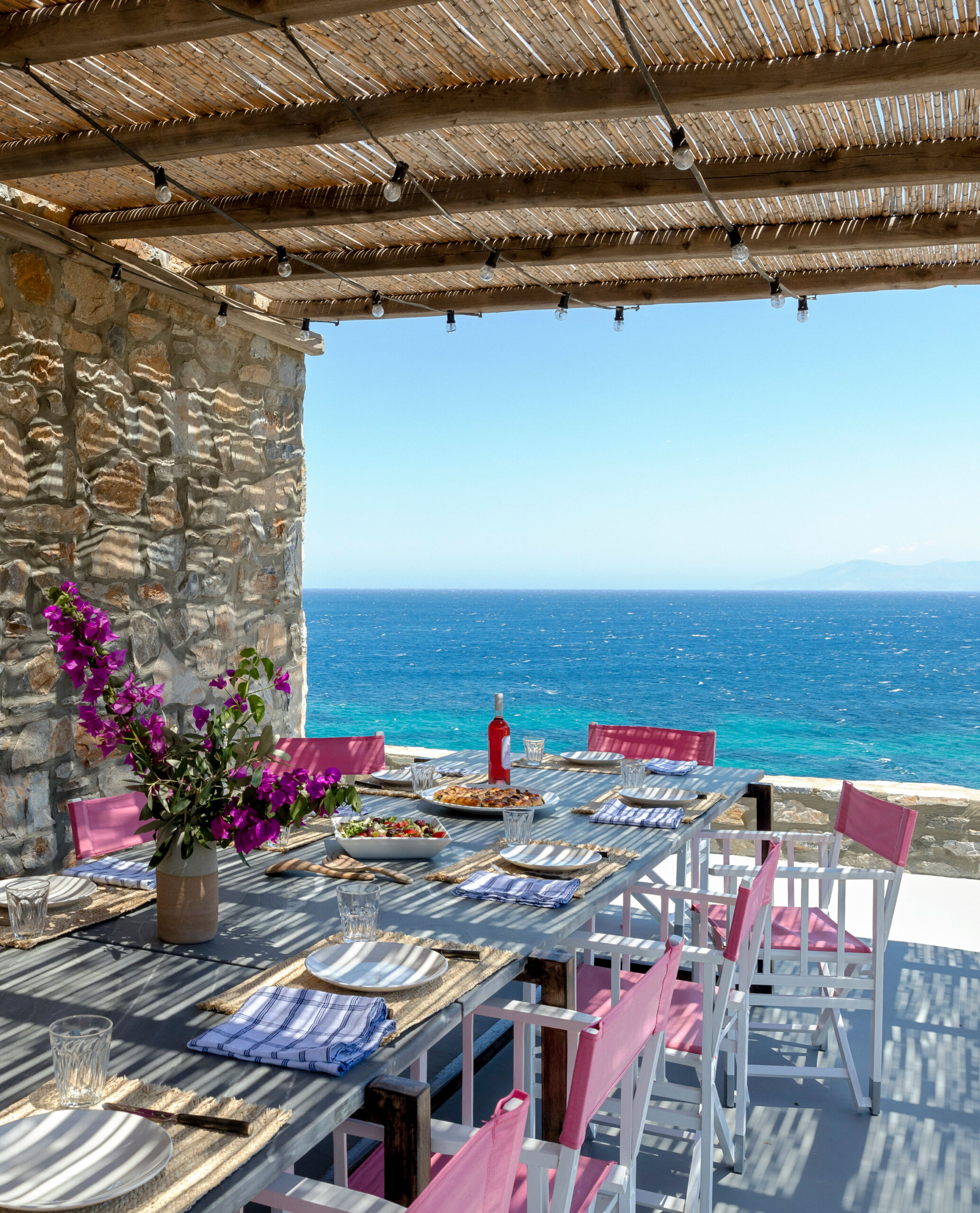 Cycladic Villa - An outdoor dining area in Scandinavian-inspired Greek villa. Design by Pembrooke...