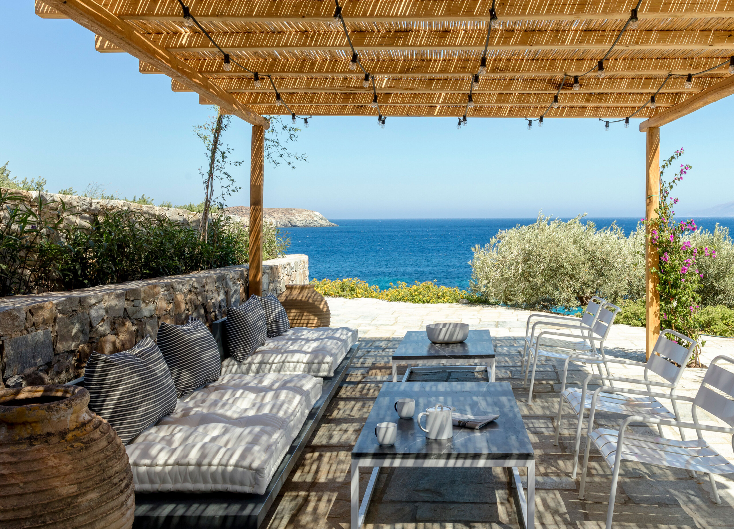 Cycladic Villa - Scandinavian-inspired outdoor patio in Greek coastal villa. Design by Pembrooke...