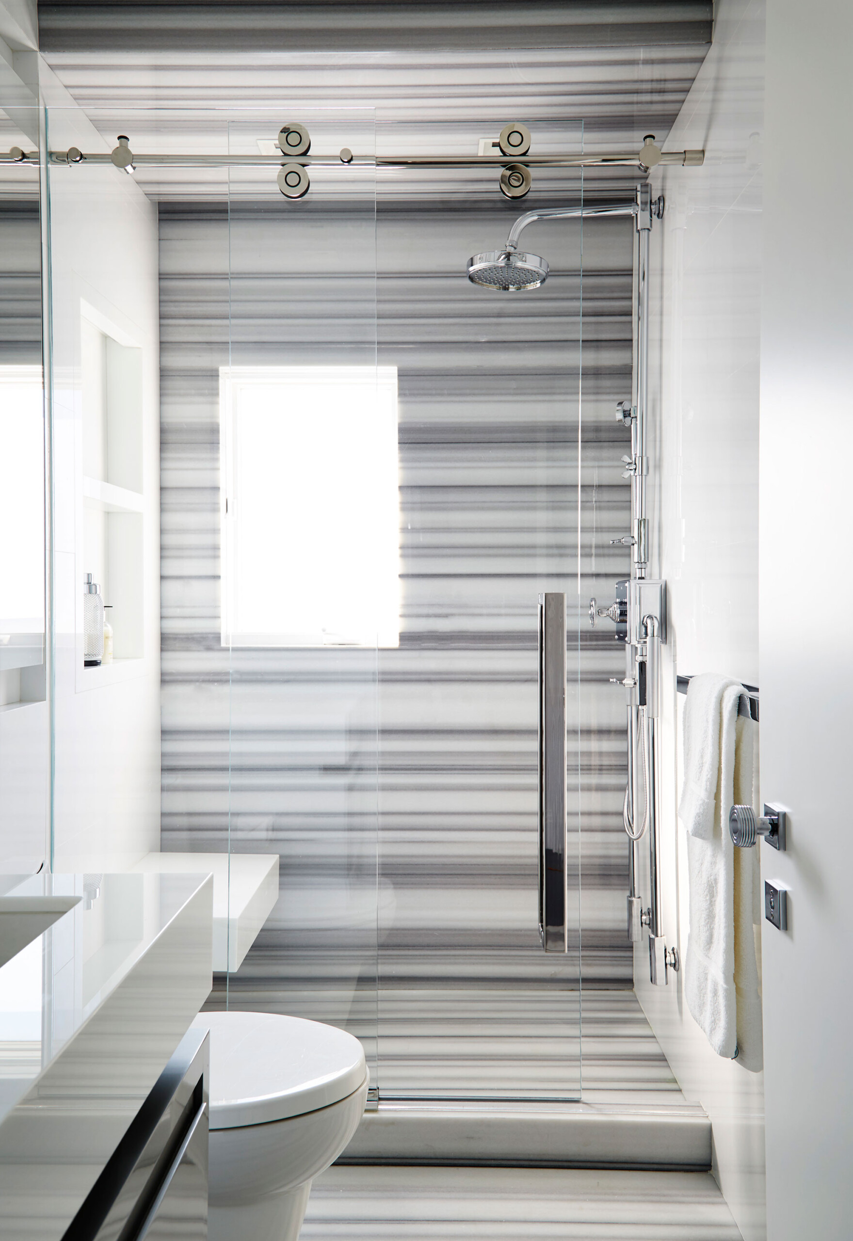 Historic West Palm Beach - White striped stone bathroom in Palm Beach, FL luxury home. Interior...