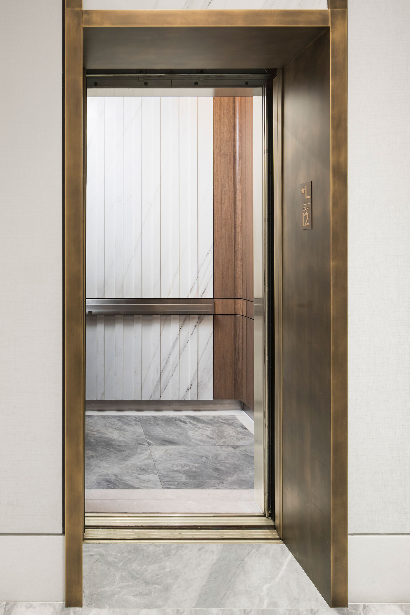 111 West 67th Street - Luxury elevator corridor in Upper West Side lobby. Bronze, marble & wood....