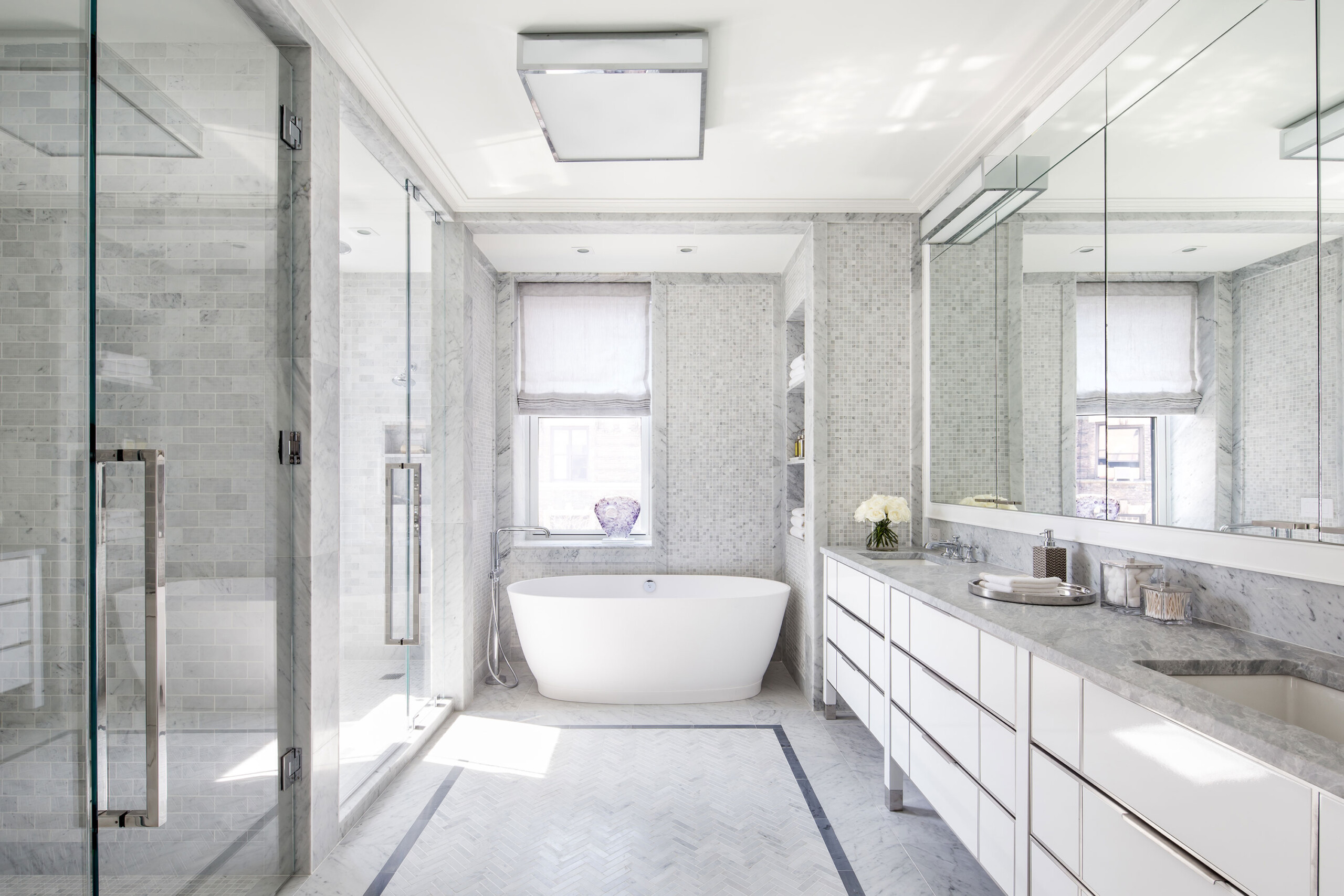 The Chatsworth - White modern luxury bathroom in New York residence. Interior design by Pembrooke...