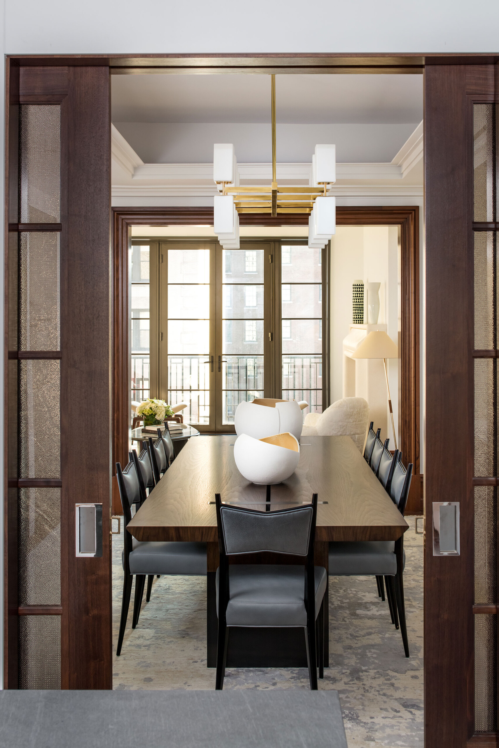155 East 79th Street - Modern dining room of New York condo with long rectangular table, grey upholstered...