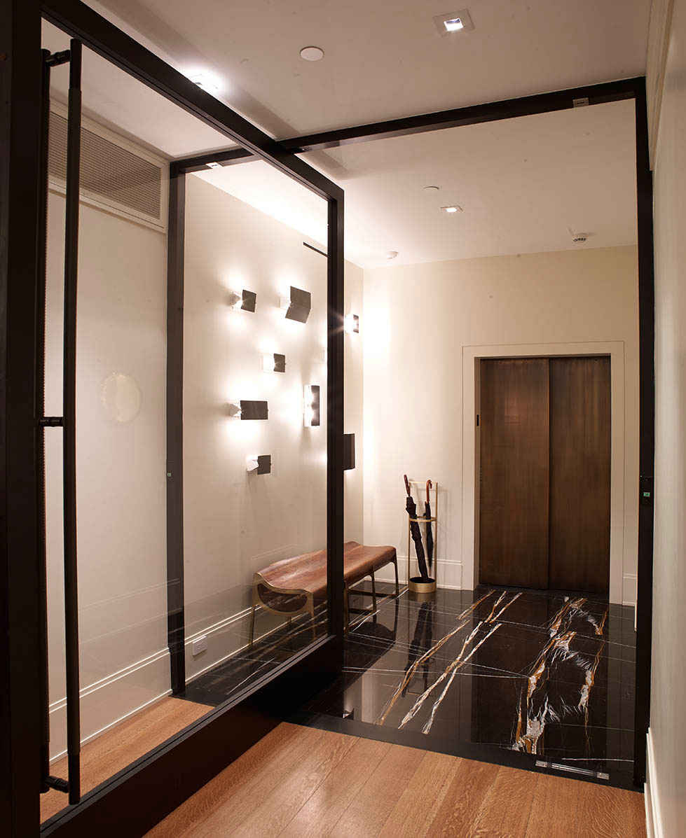 Madison Square Park - Modern elevator entryway of New York apartment with glass facade and black...