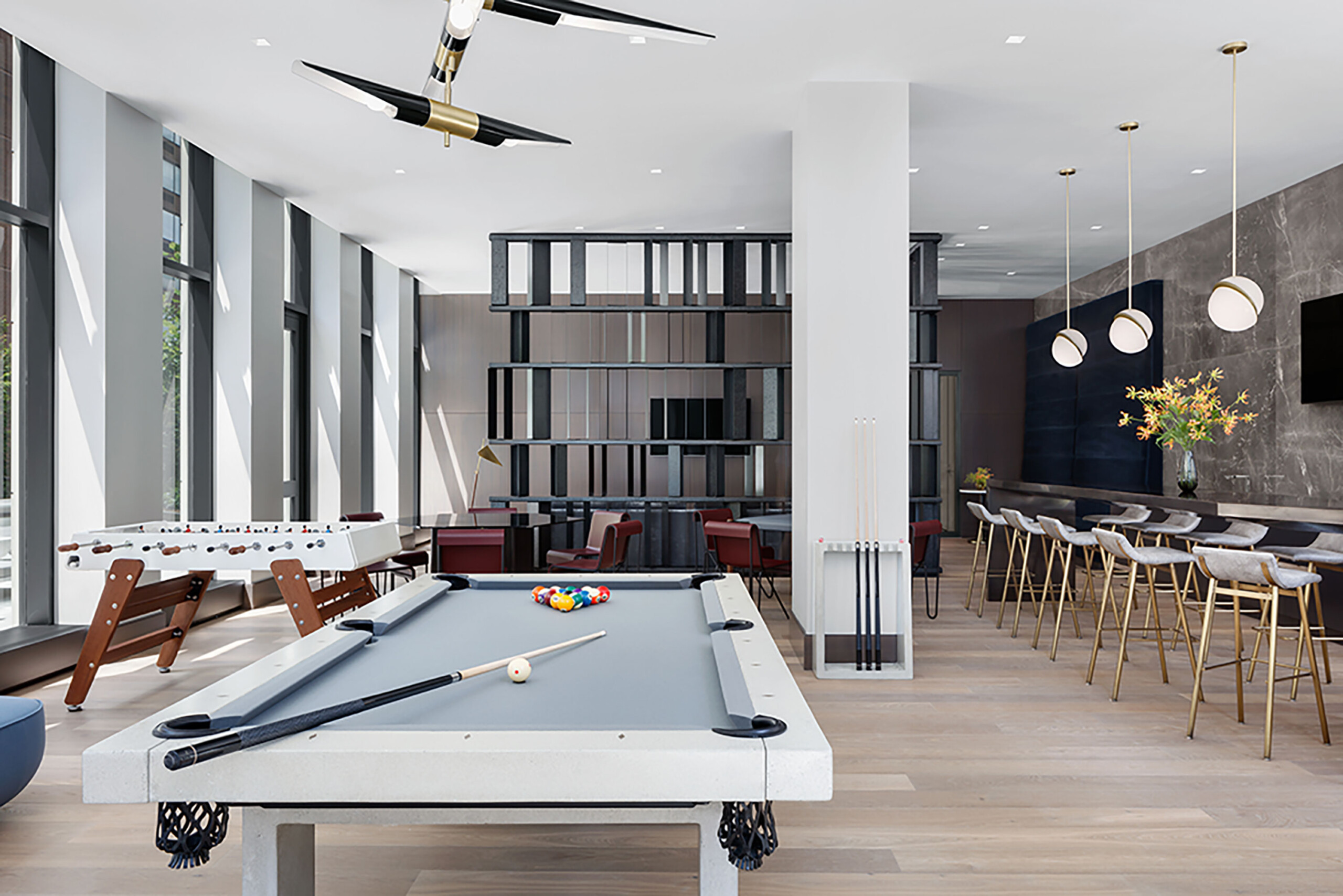 The Park Loggia - Modern game room design with pool table, foosball table, and lounge areas. Interior...