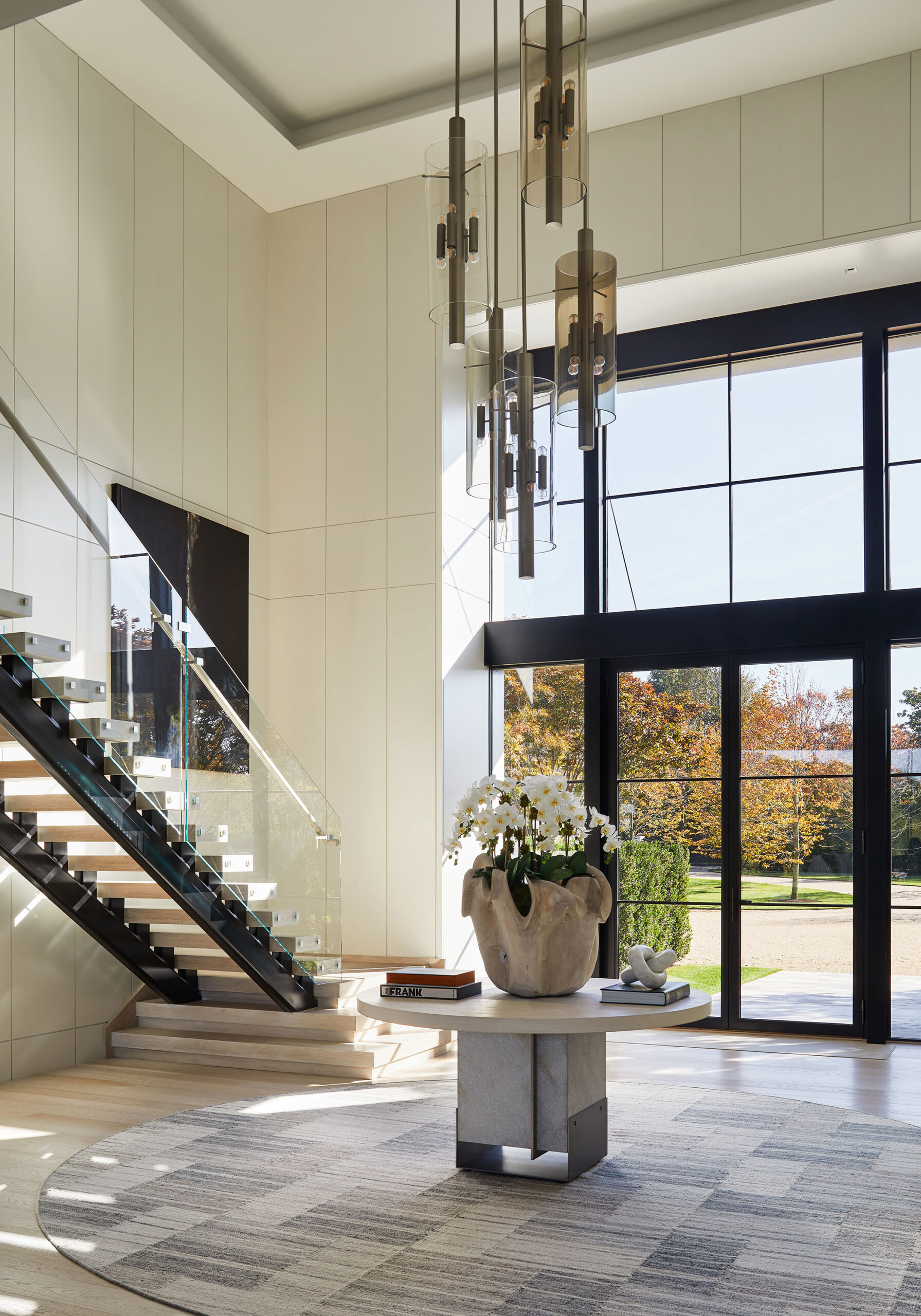 Southampton Estate - Pembrooke & Ives - Entryway in a Southampton estate, featuring a central entry...