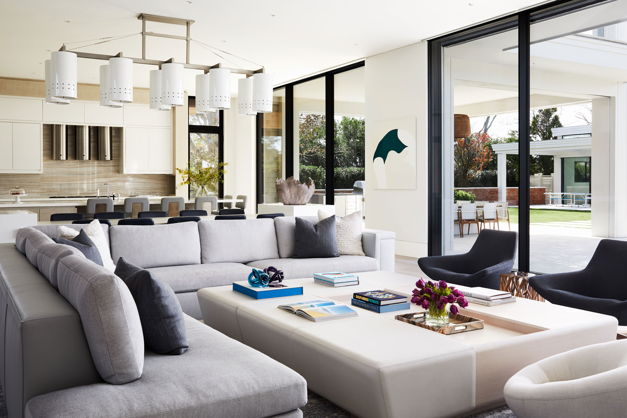 Southampton Estate - Pembrooke & Ives - Open-concept living room with L-shaped sofa, large coffee...