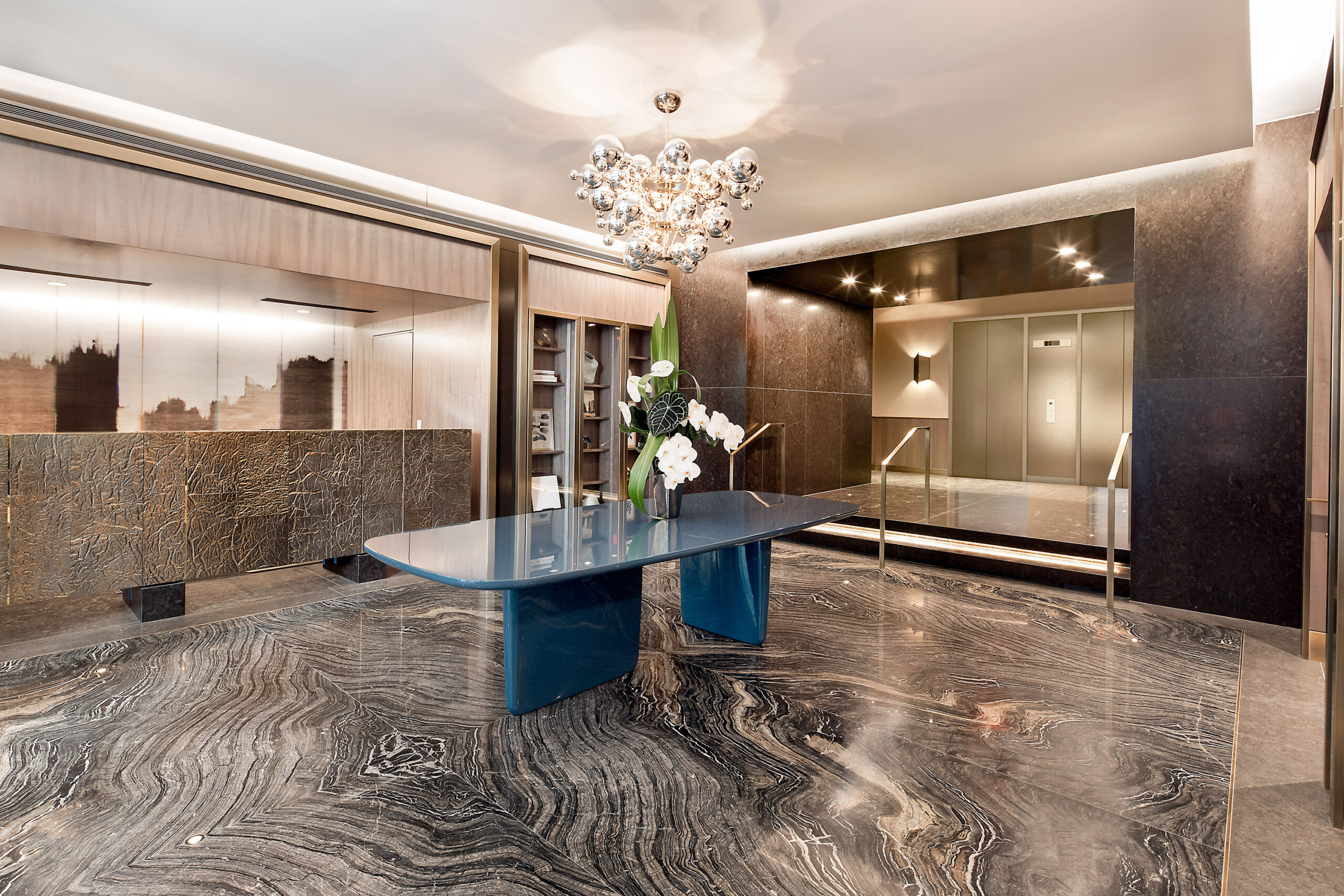212 Fifth Avenue - Luxury lobby design of New York condo building featuring stone reception desk,...