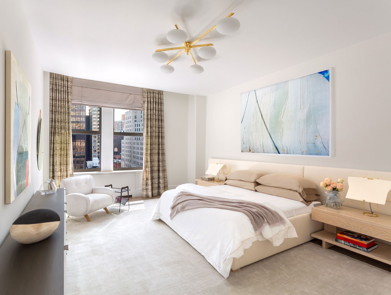 212 Fifth Avenue - Modern bedroom in New York condo with neutral tones, brass and white chandelier,...