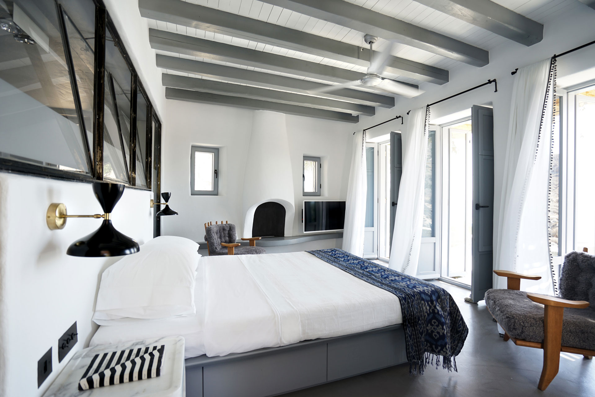 Cycladic Villa - A Scandinavian-inspired bedroom with modern touches. Interior design by Pembrooke...