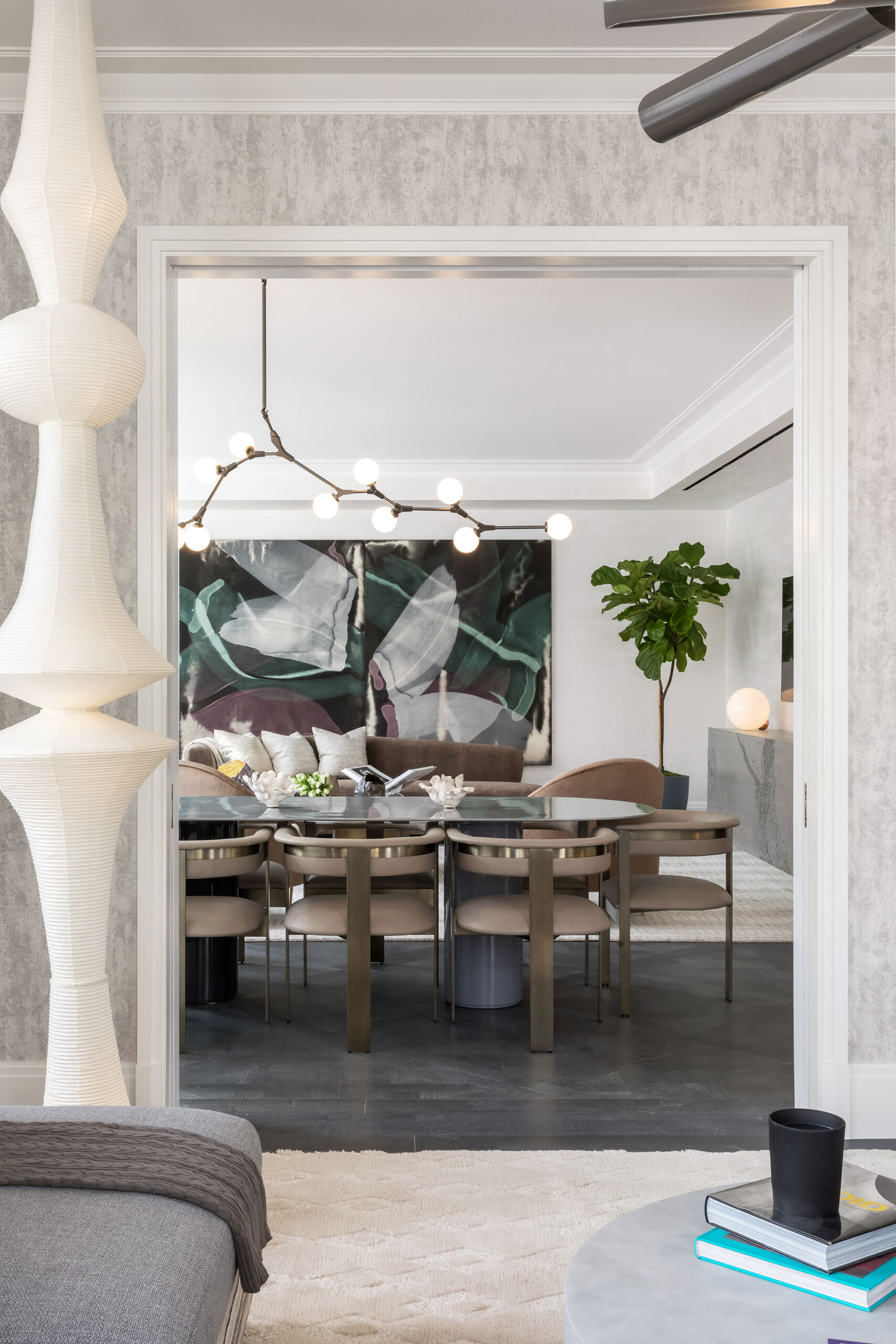1010 Park Avenue - Modern dining room with taupe upholstered chairs, modern abstract wall art,...