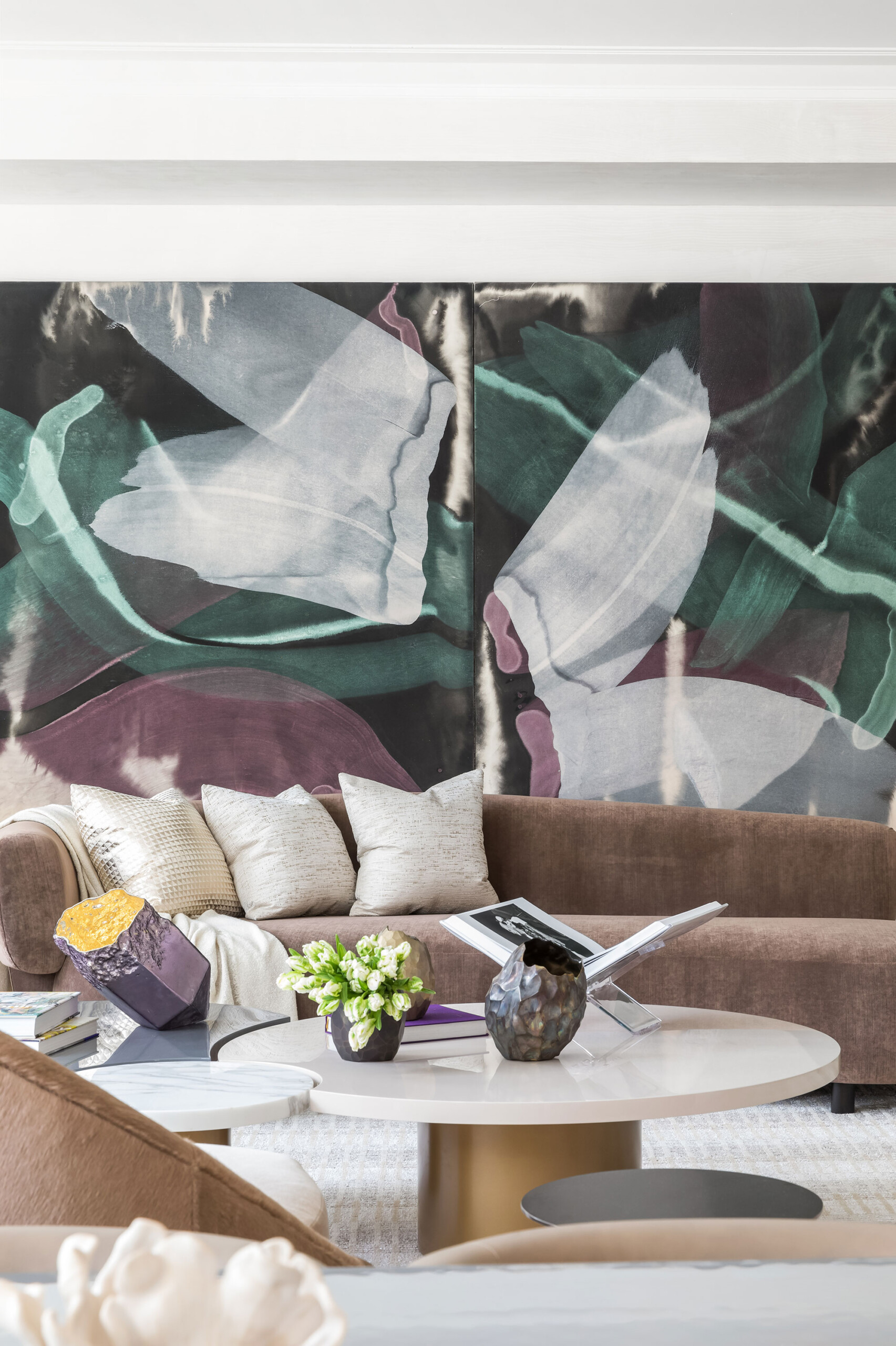 1010 Park Avenue - Detail of modern living room with stone and brass coffee table, taupe sofa,...