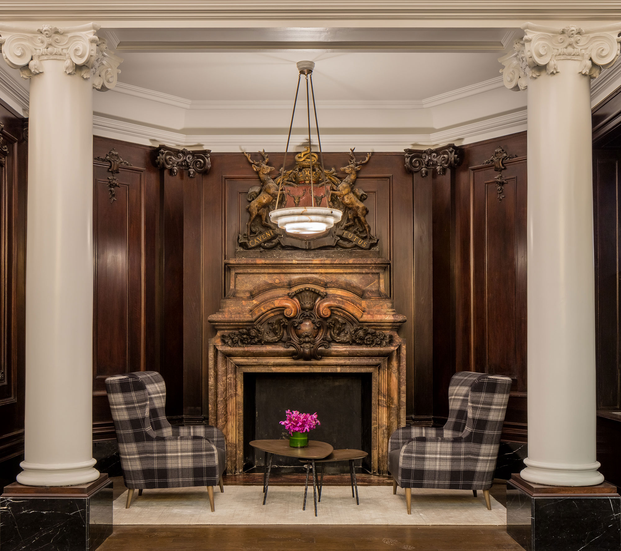 The Chatsworth - The Chatsworth luxury lobby fireplace and lounge area with Ionic column architecture....