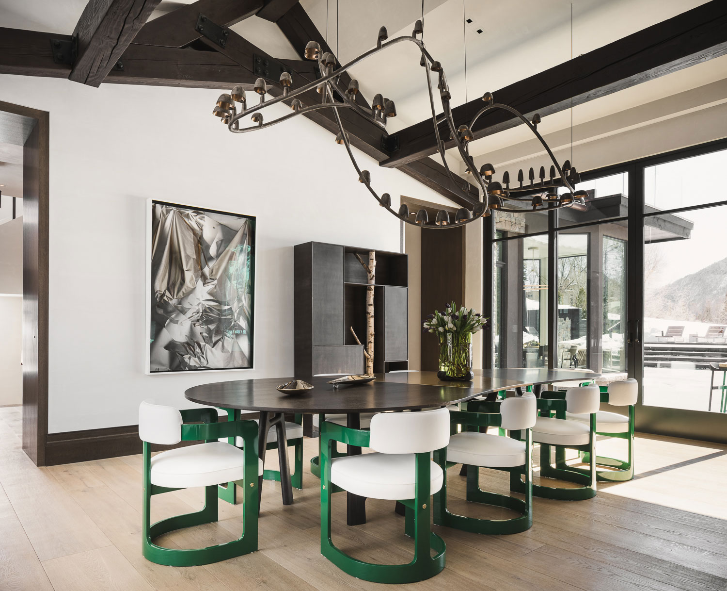 Red Mountain - Dining room of mountain vacation home with organic-shaped black chandelier and rounded...