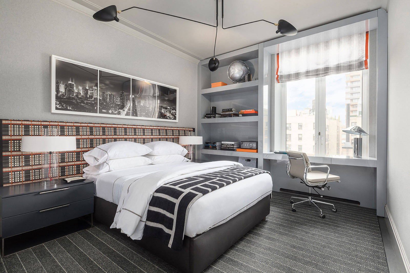 1010 Park Avenue - Primary bedroom of New York home with built-in shelving. Grey tones and clean...