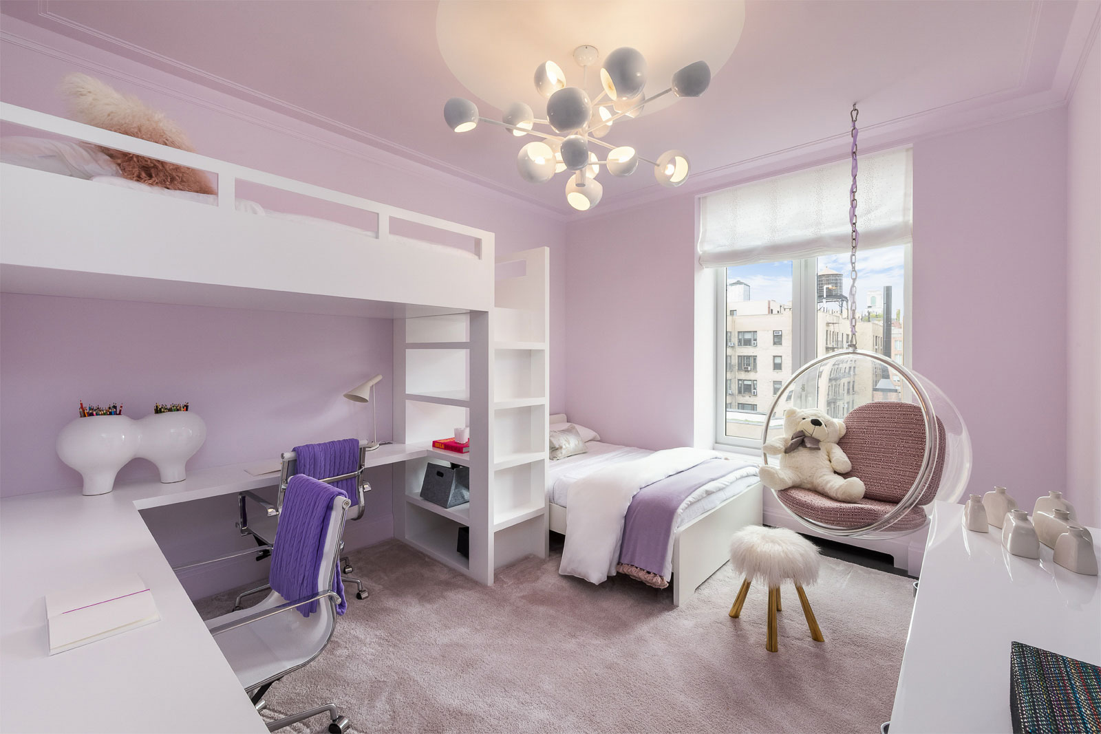 1010 Park Avenue - White and purple child's bedroom with lofted bed, desk, hanging chair, and chandelier....