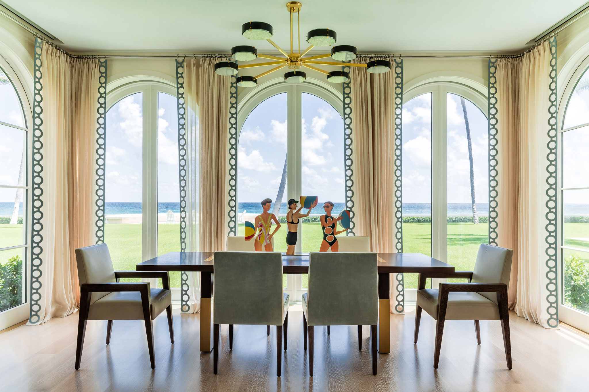 Ocean-front Compound - Modern dining room with large arched window and contemporary dining table,...