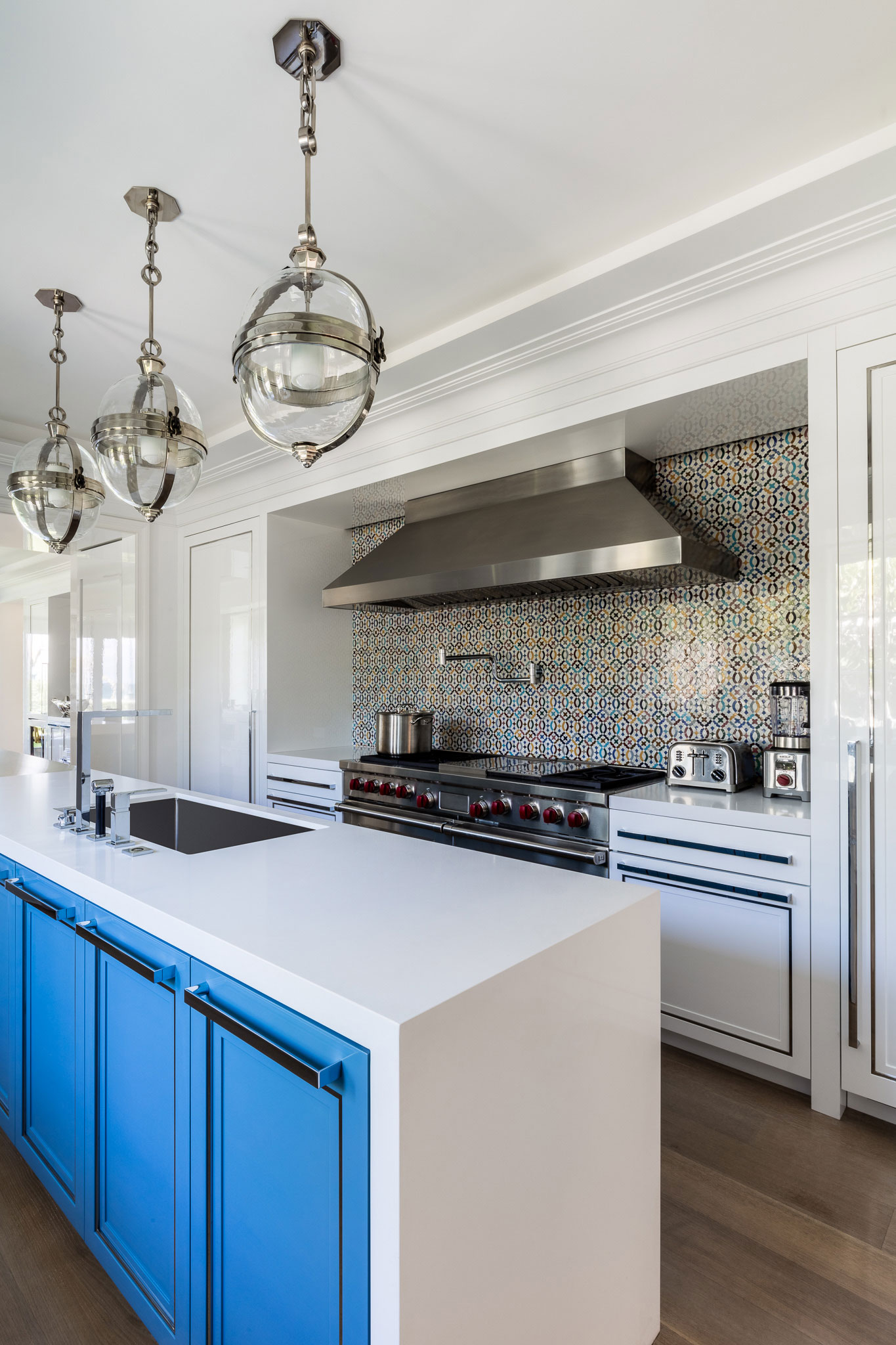 Ocean-front Compound - Modern kitchen with stainless steel hood, white counters, and blue accent...