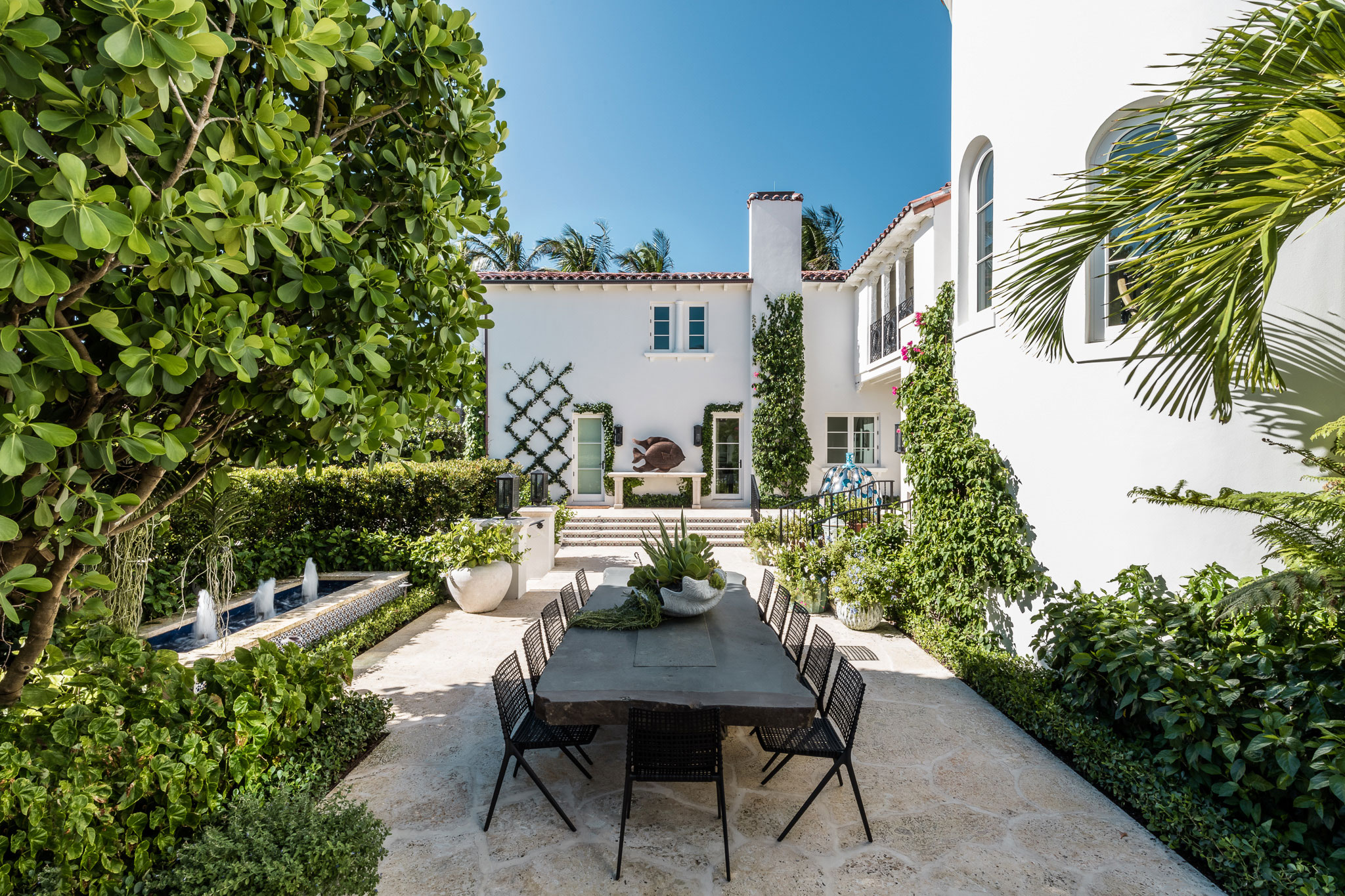 Ocean-front Compound - Lush outdoor patio with greenery and stone flooring. Design by Pembrooke...