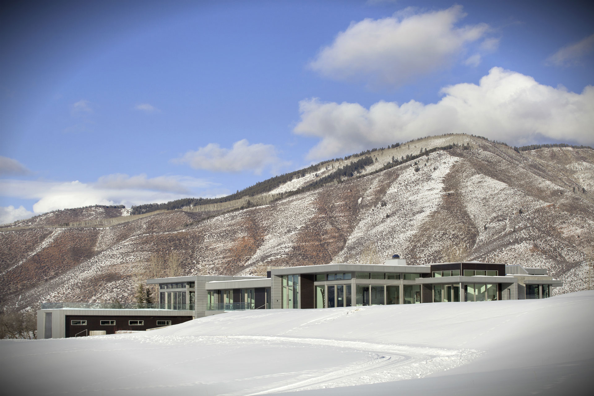 Modern Mountain - Exterior of modern home with mountain scenic view. Interior design by Pembrooke...