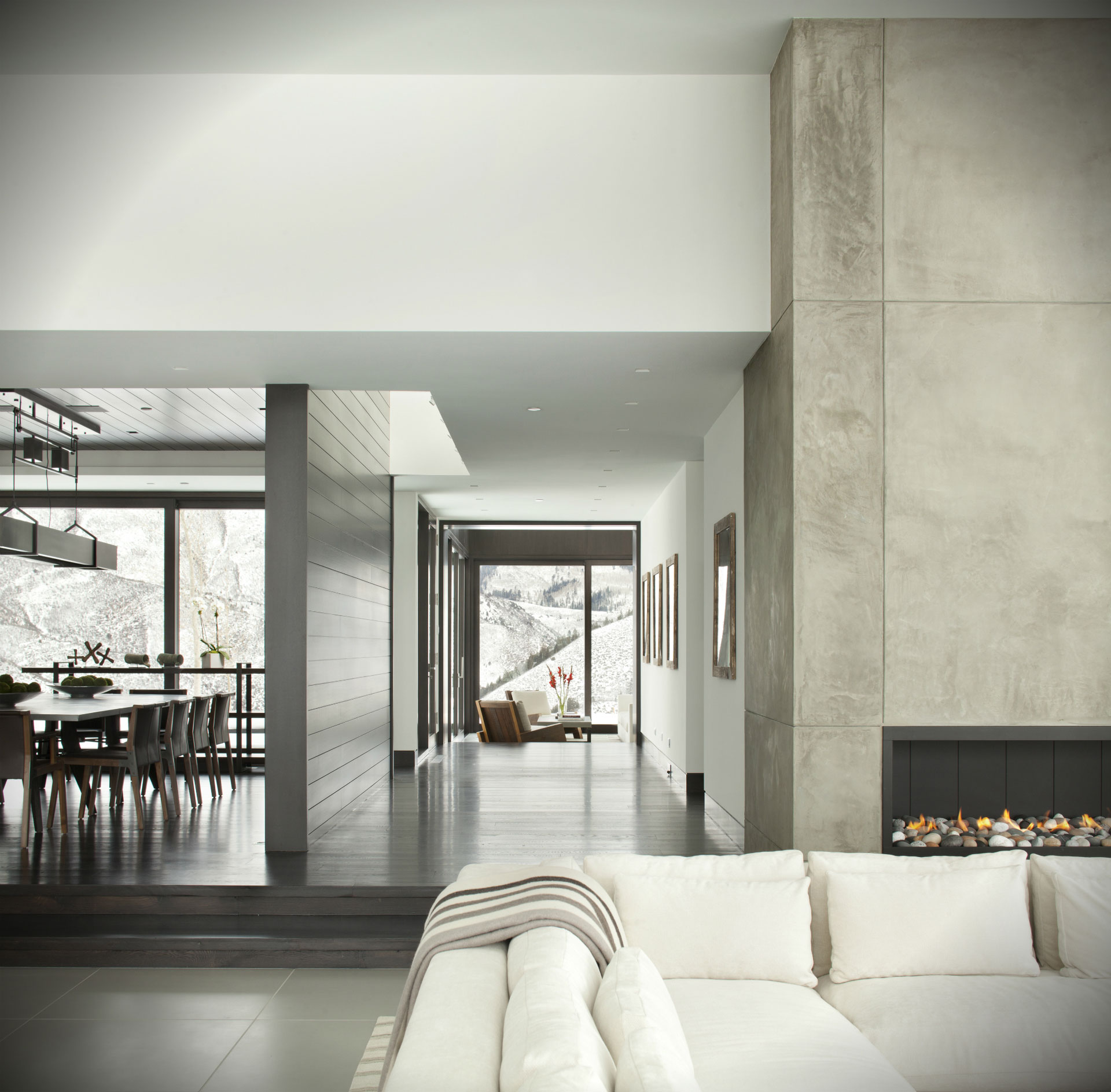 Modern Mountain - Hallway of modern home with scenic mountain view. Neutral tones and natural stone...