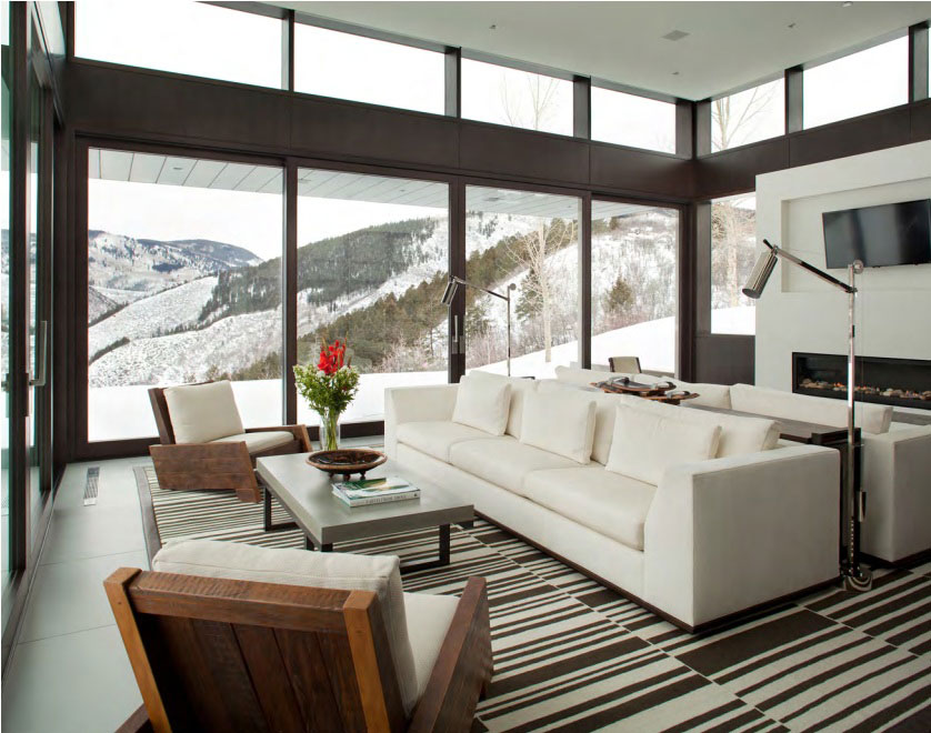Modern Mountain - Living room with modern furniture, cream sofa and cream and wood chairs, and...