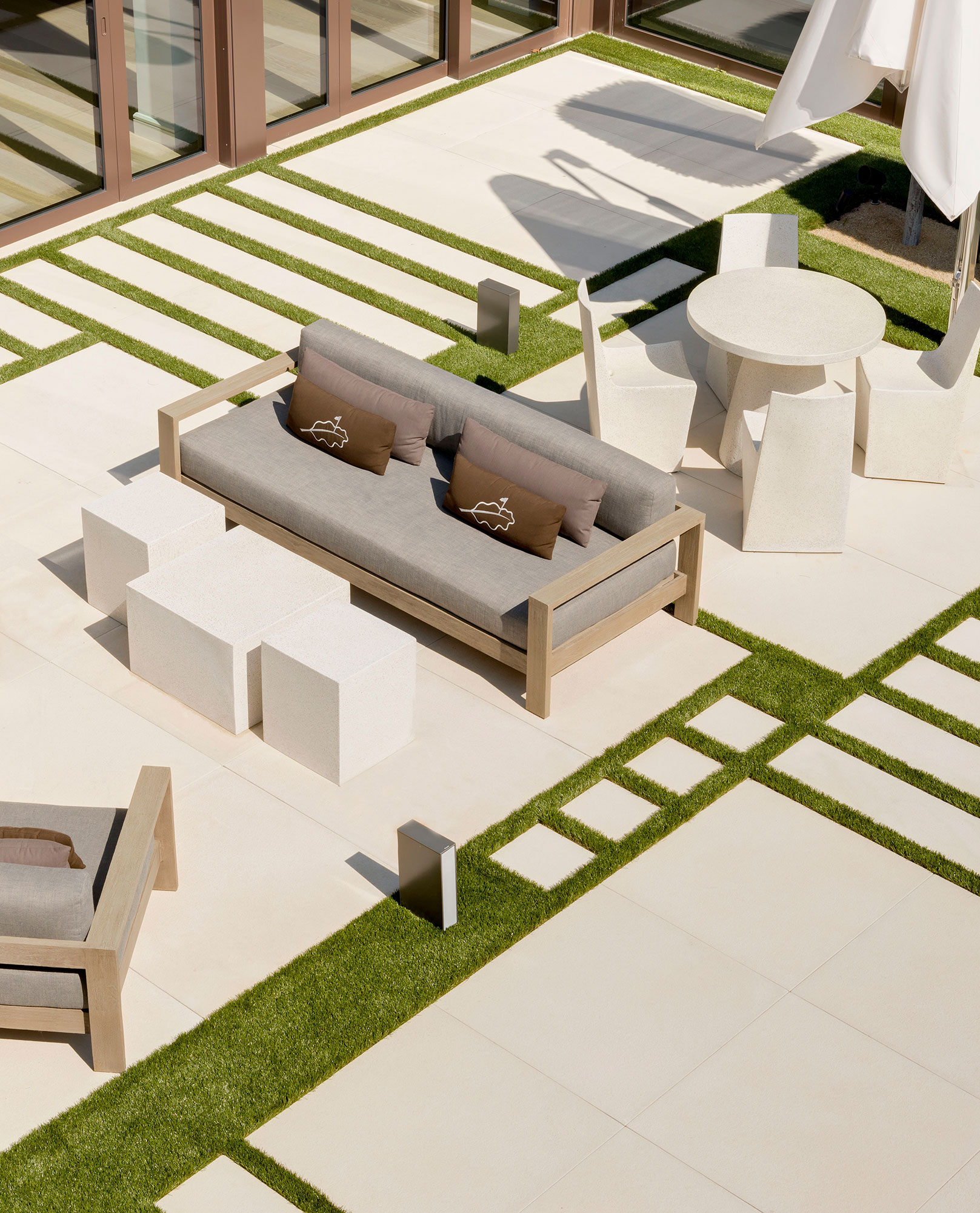 Glen Oaks Club - Modern outdoor patio seating of Long Island country club. Hospitality design by...