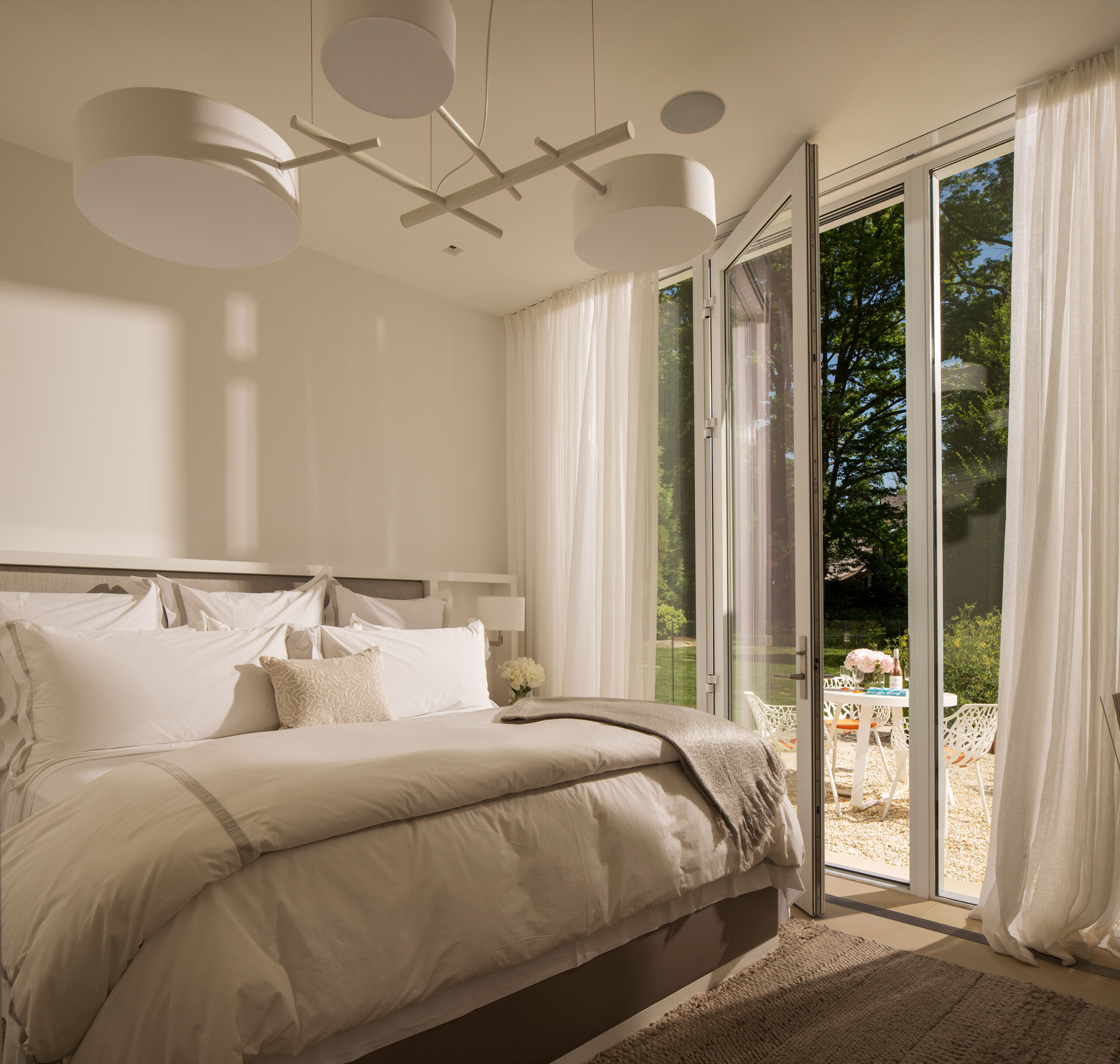 Rye Pool House - Light and airy bedroom in Rye pool house. Interior design by Pembrooke & Ives....