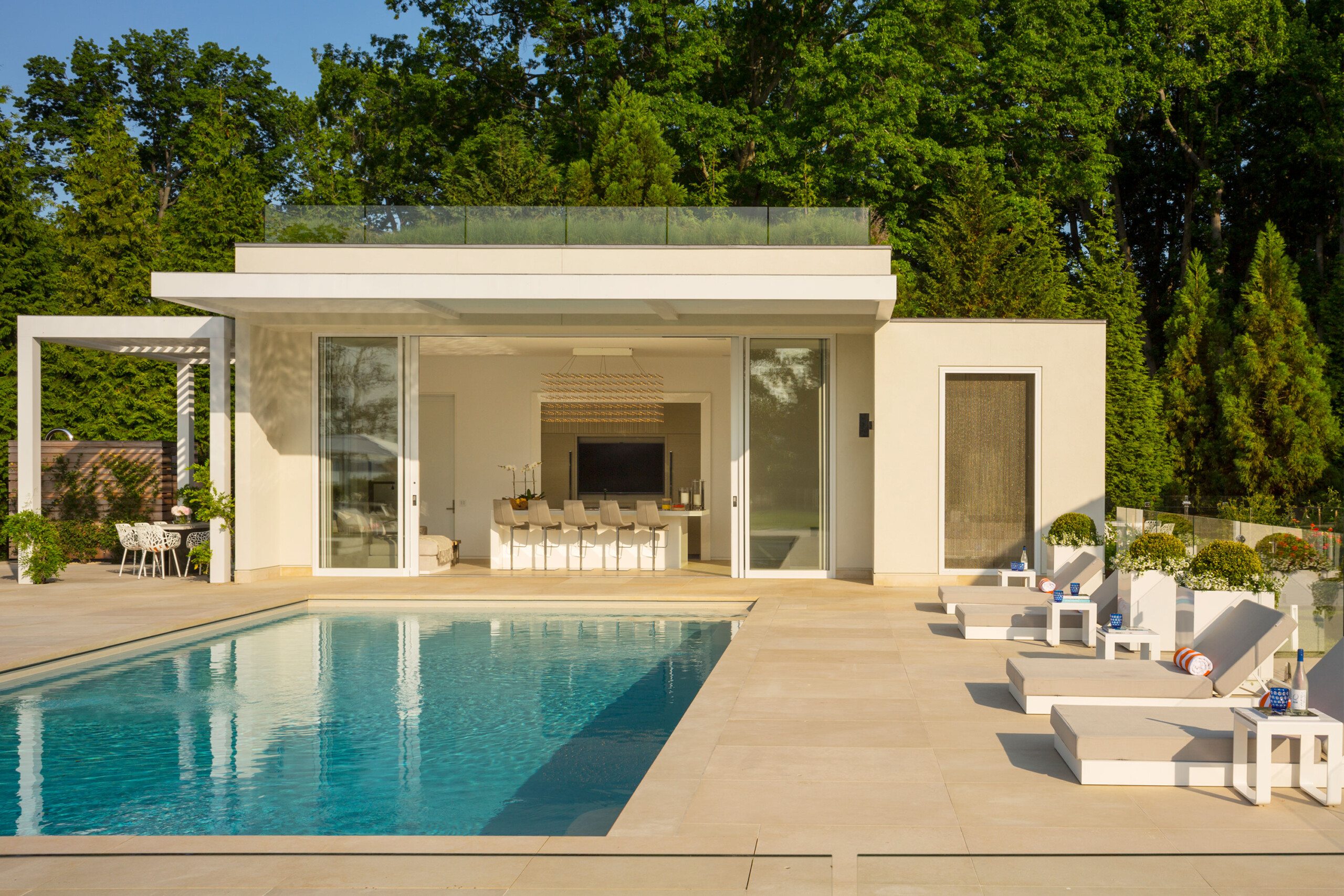 Rye Pool House - Luxury pool and lounge area of modern pool house. Design by Pembrooke & Ives....