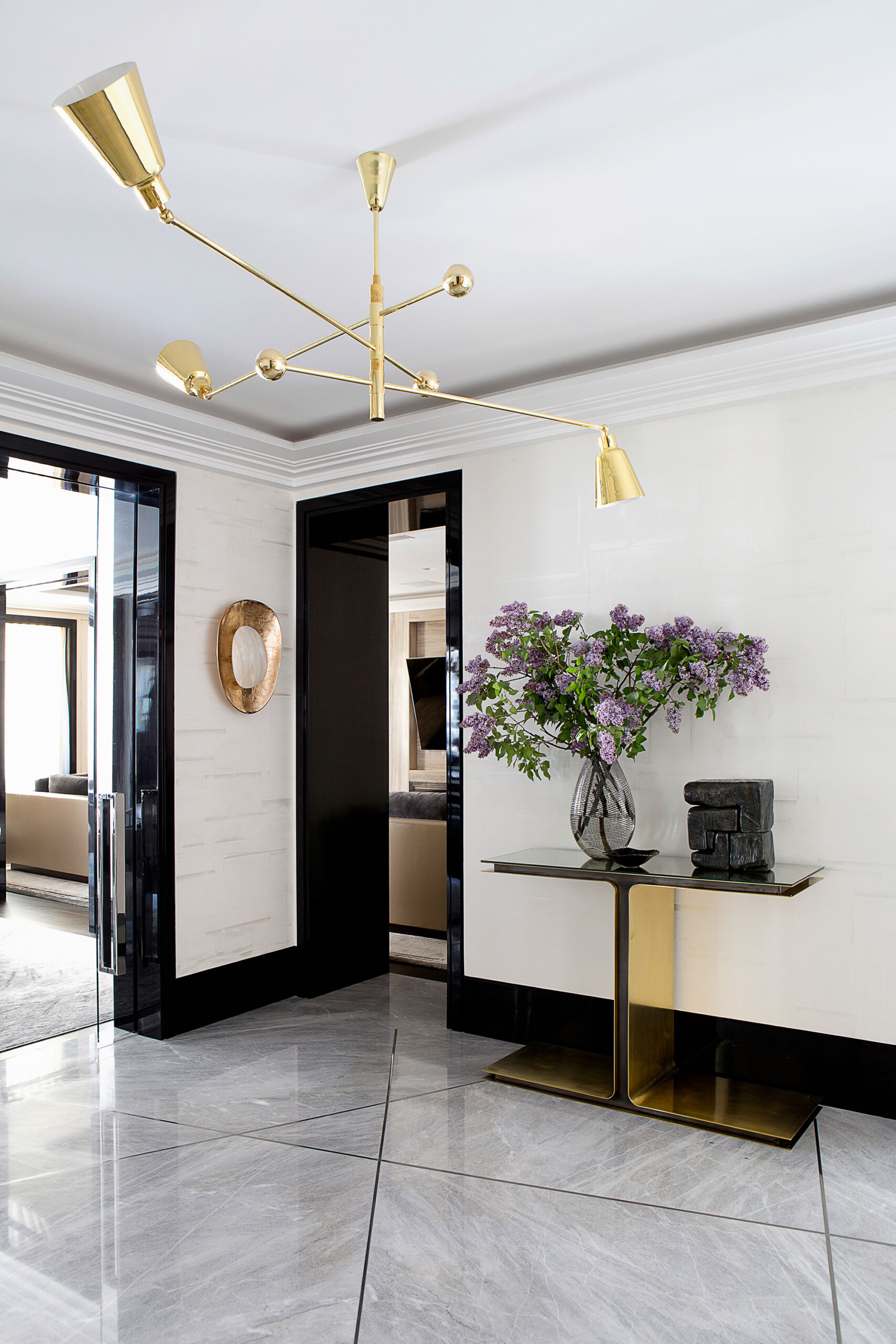 Glamour on Park - Luxury entryway with black, white, and gold color scheme. Interior design by...