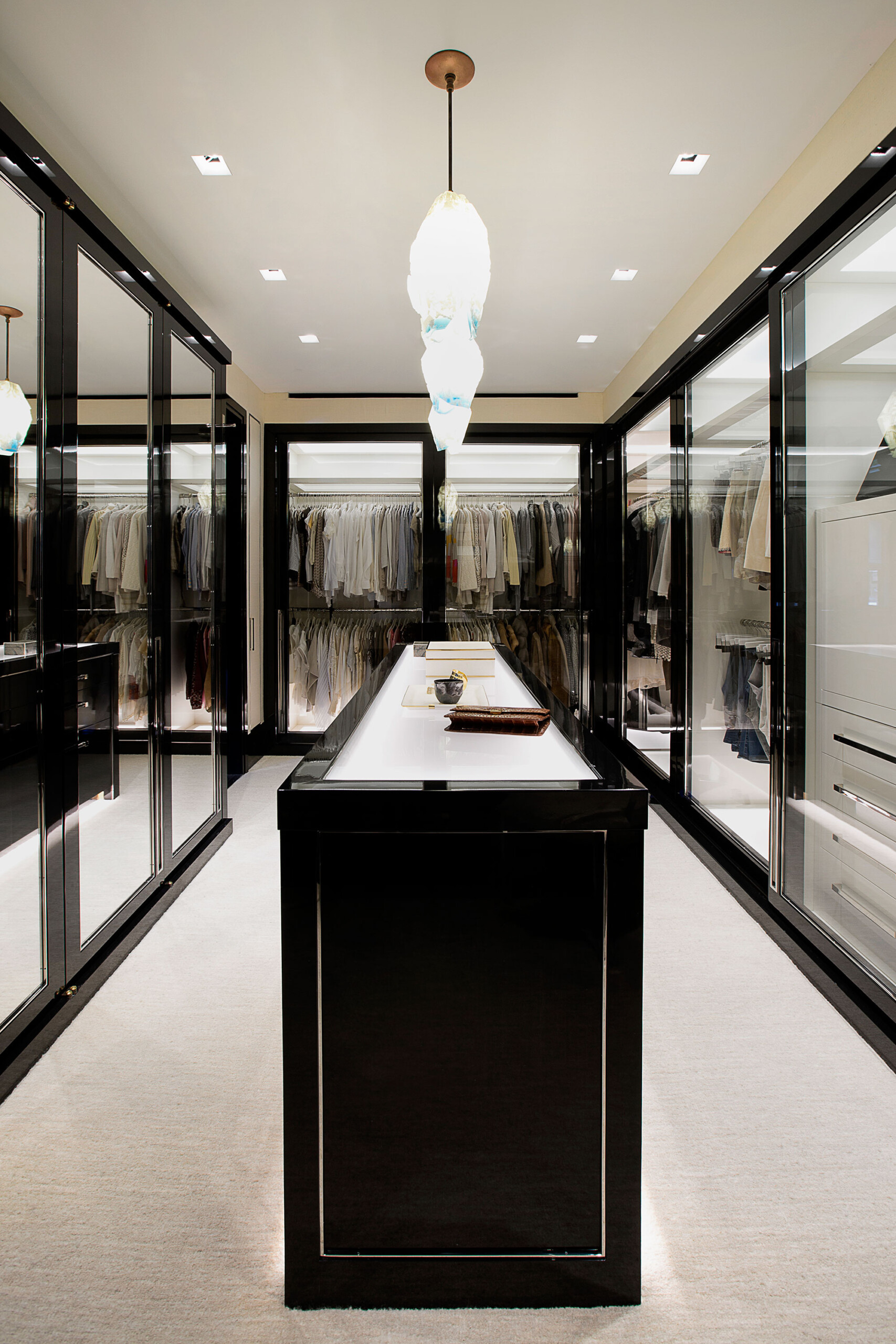 Glamour on Park - Luxury walk-in closet of Park Ave home, featuring glossy black and chrome finishes...
