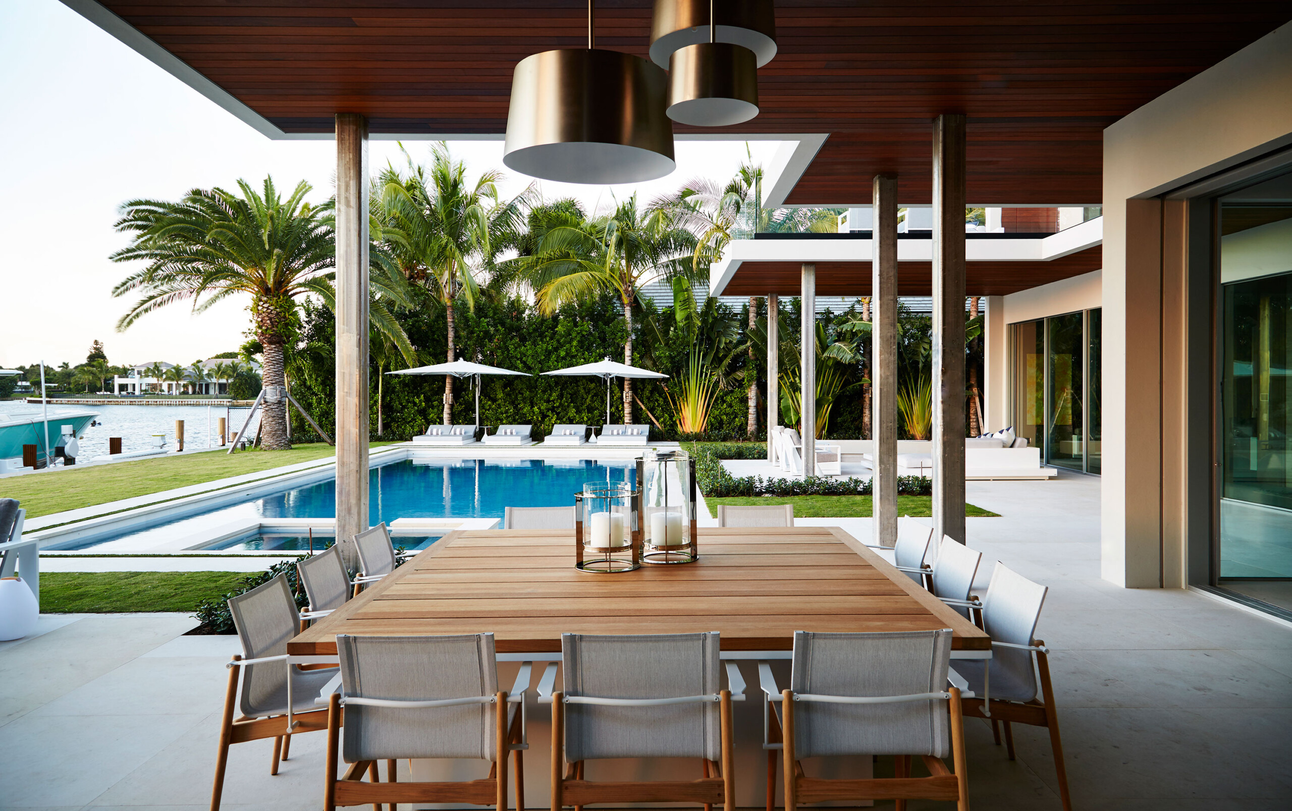 Lost Tree Way - Outdoor patio of modern Palm Beach, FL home with dining table and pool area. Design...