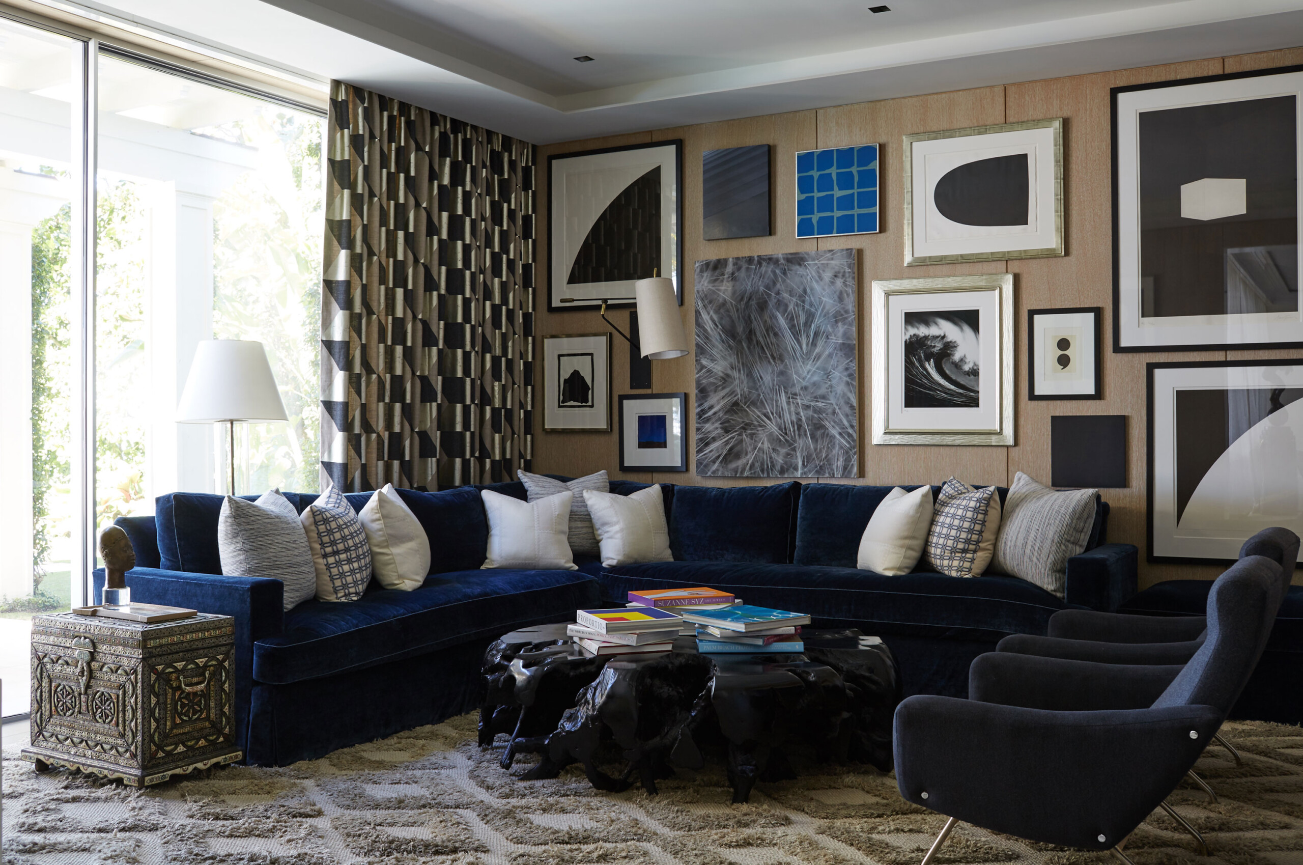 Lakefront Home - Living room with navy blue sofa, textured rug, and modern art. Interior design...