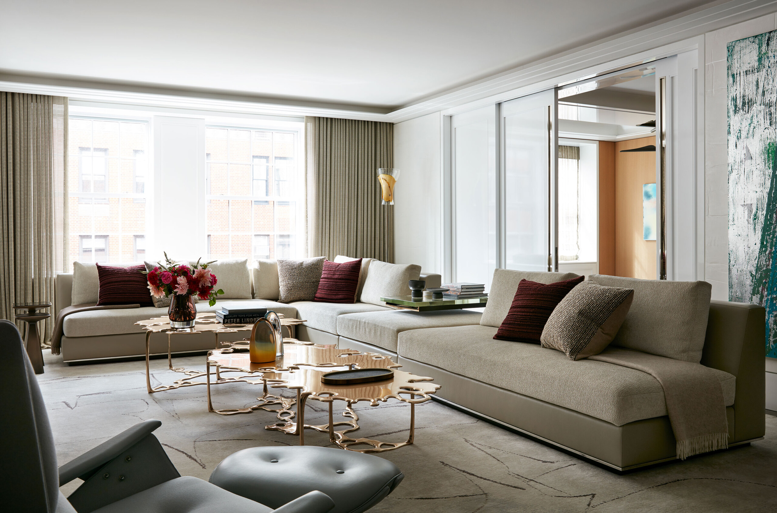 Park Avenue - Modern living room with neutral tones and extra large sectional sofa. Statement copper...