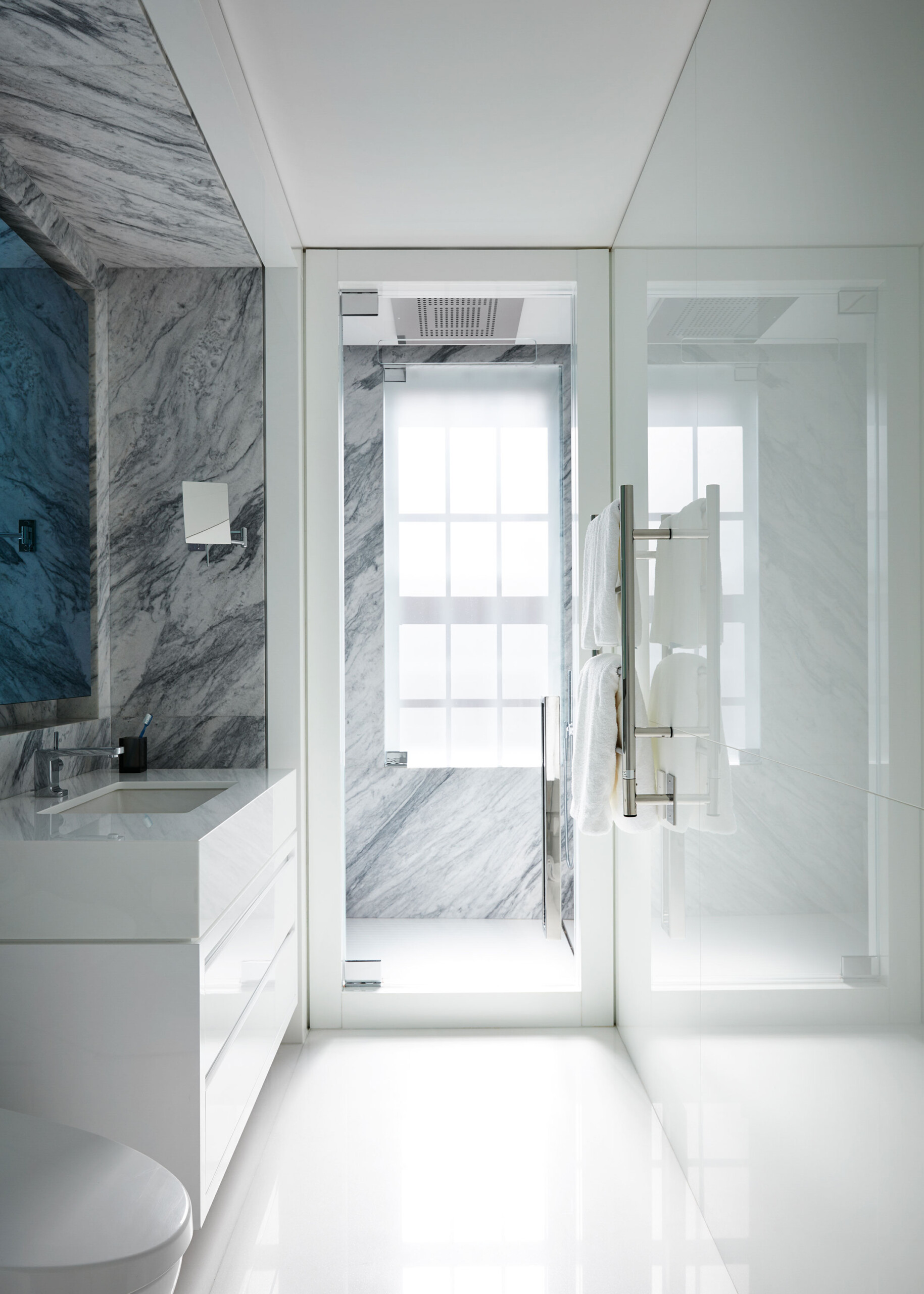 Park Avenue - Luxury white bathroom with marble walls and clean bright design. Interior design...