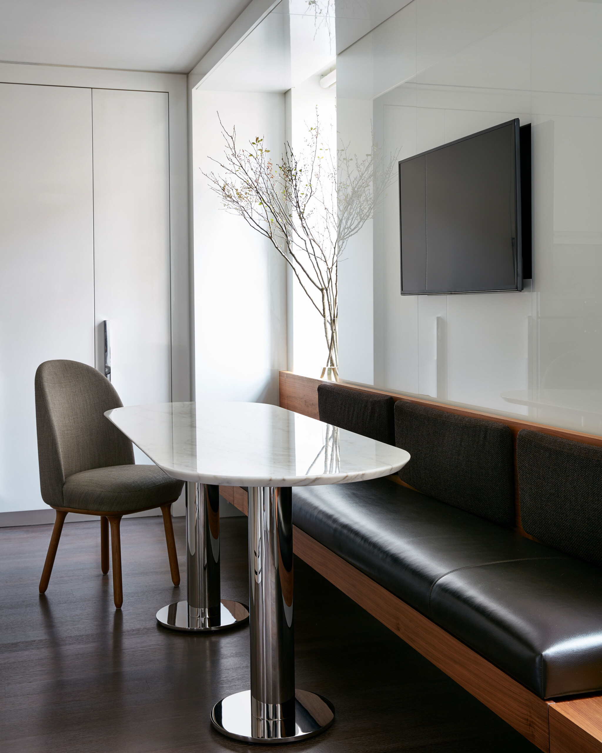 Park Avenue - Eat-in kitchen dining area with black leather bench seating and white oval table,...
