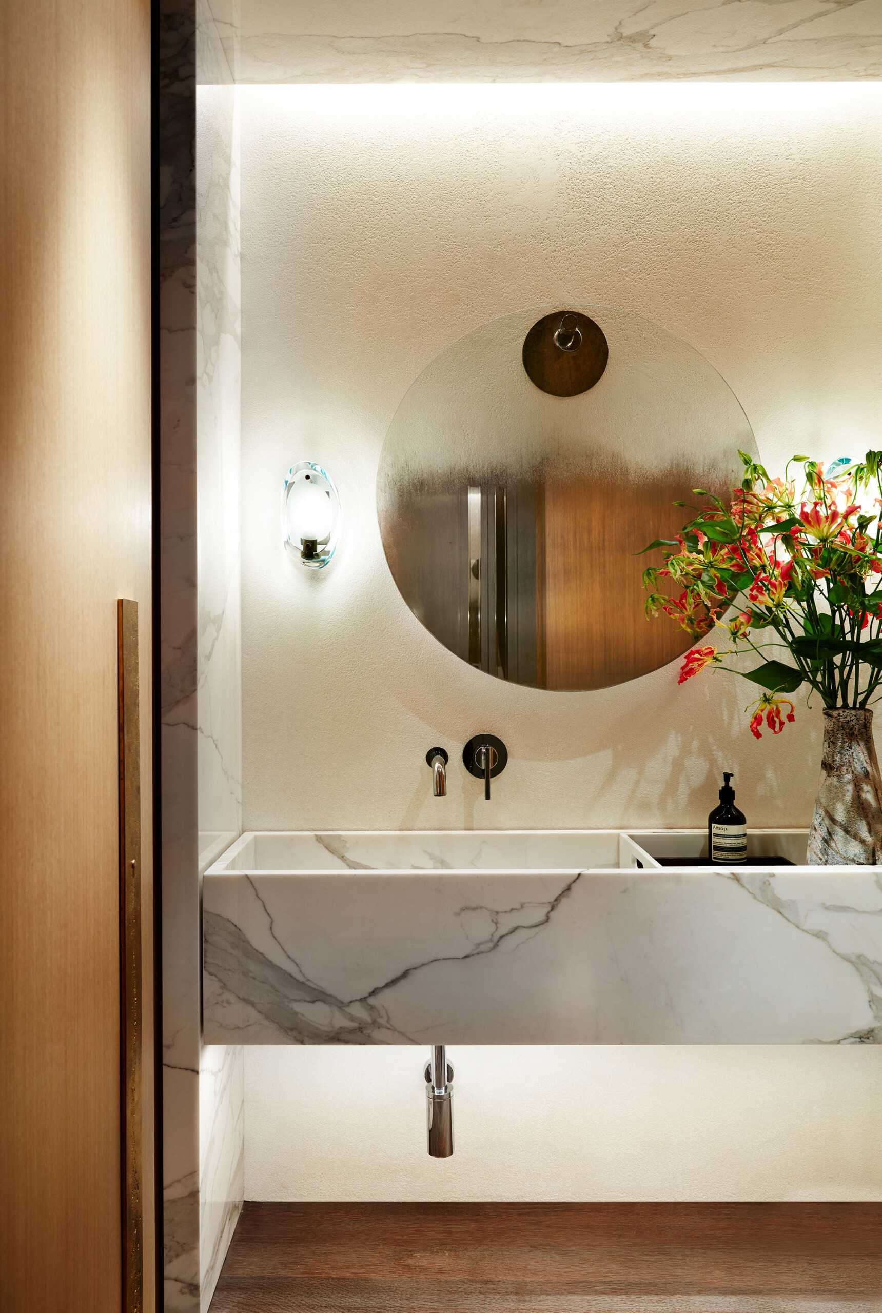Park Avenue - Luxury powder room vanity with white marble sink and round mirror. Interior design...
