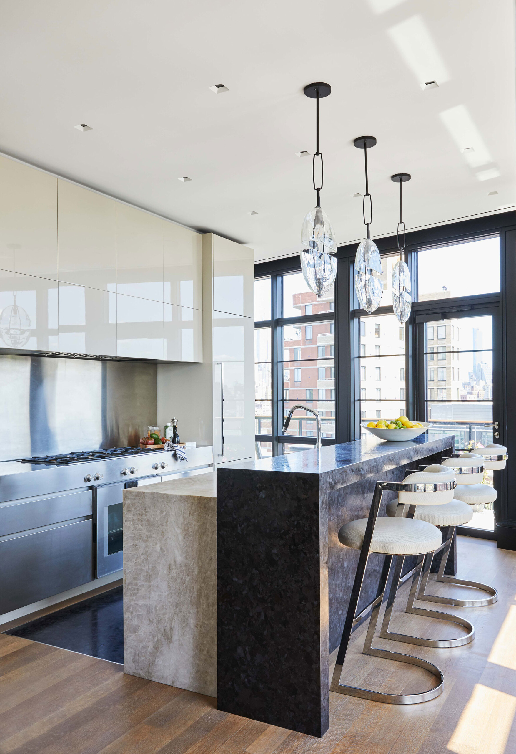West Village Penthouse - Pembrooke & Ives Modern kitchen with glossy white cabinetry, two-tone...