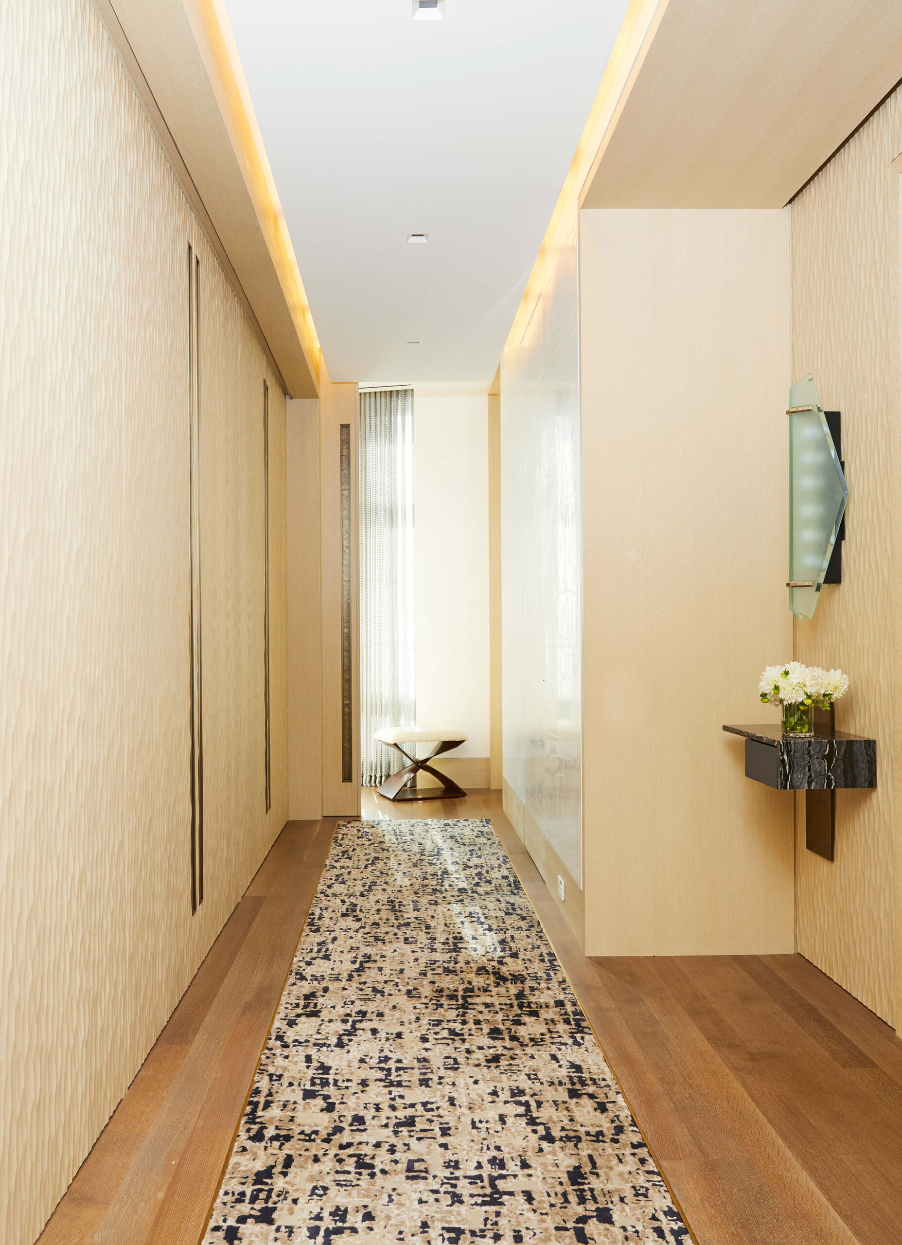 West Village Penthouse - Pembrooke & Ives Main hallway of New York home with warm tones, stone...