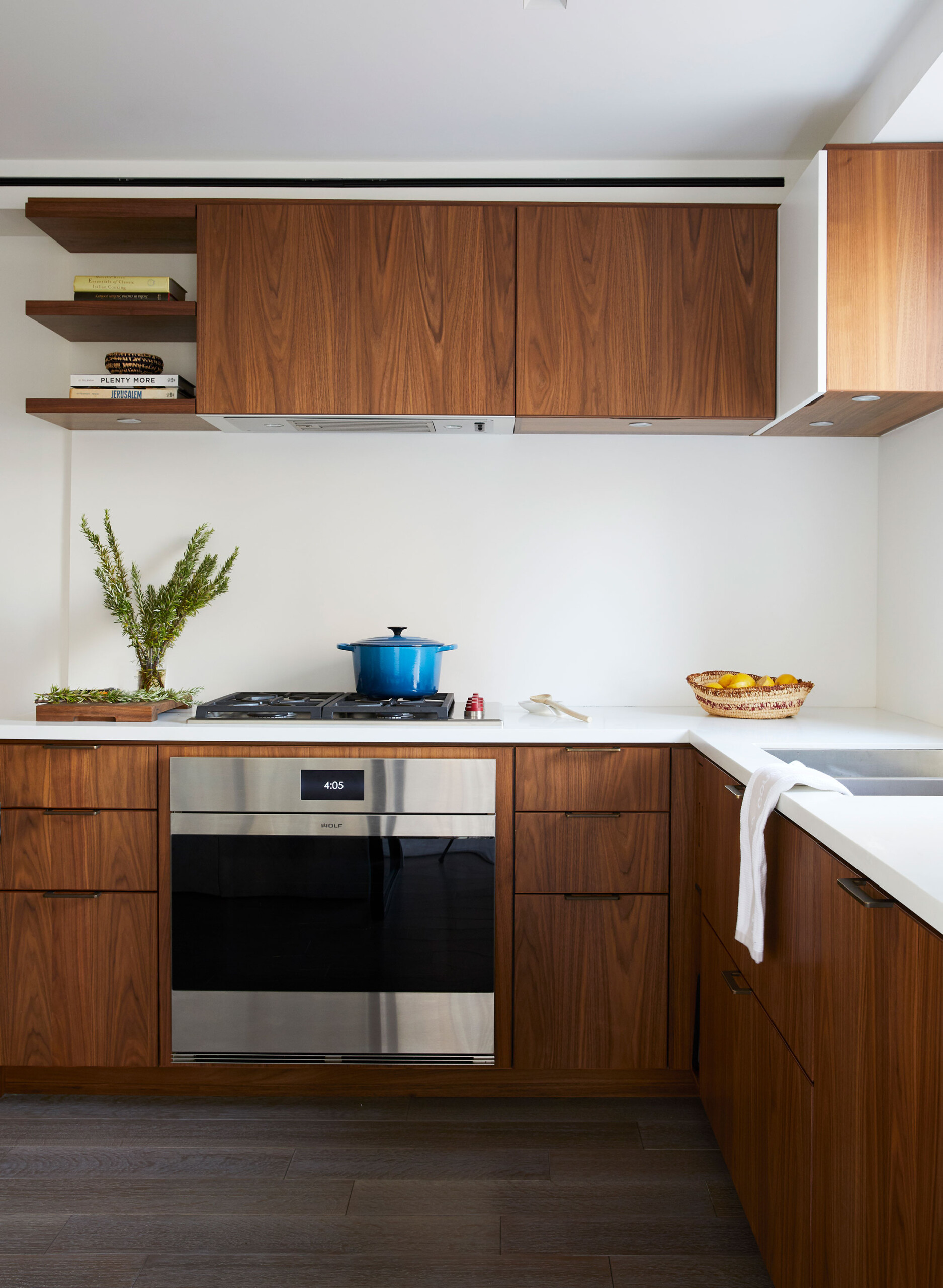 Uptown Pied-a-Terre - White and walnut cabinets and countertops in mid-century modern kitchen,...