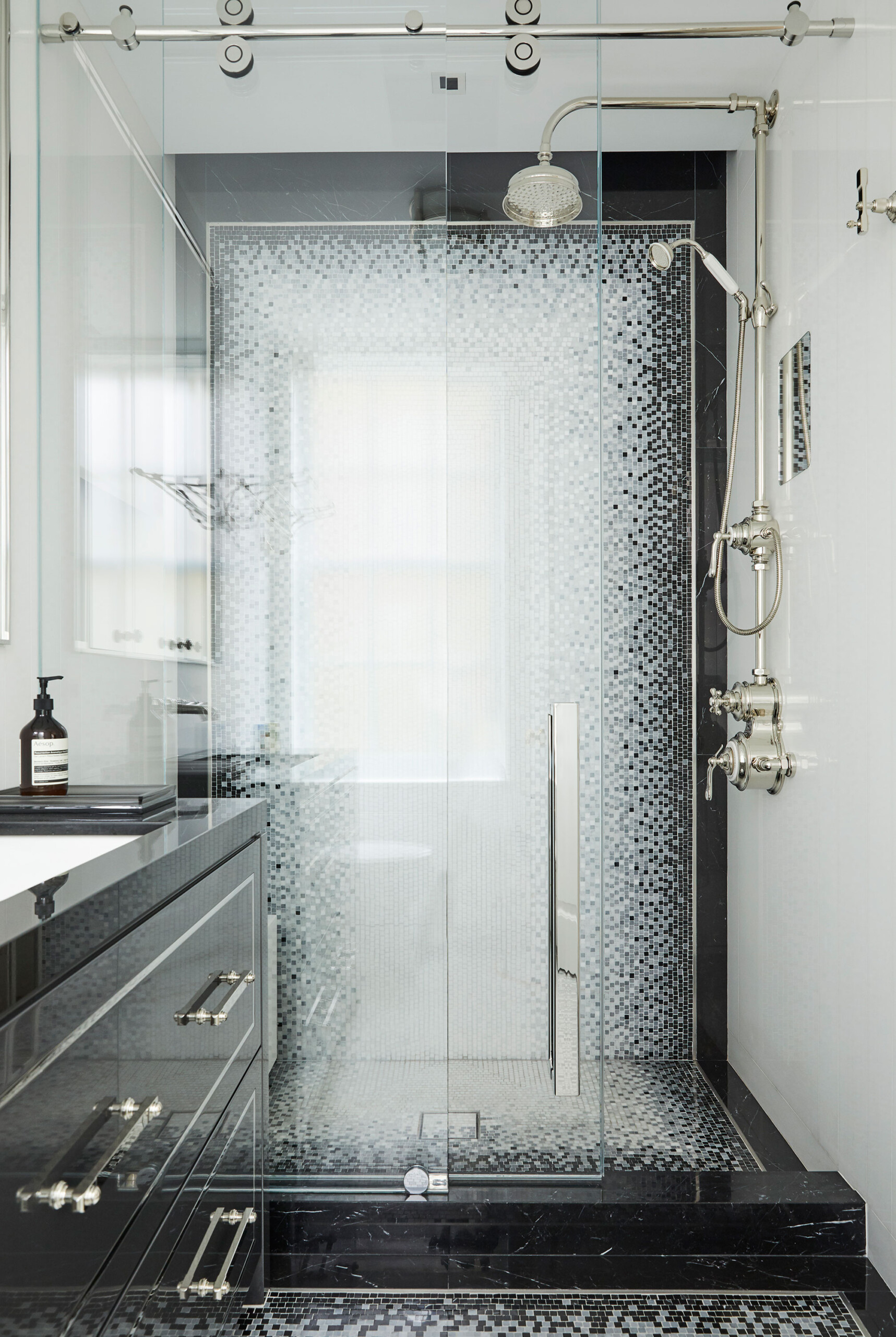 Uptown Eclectic - Pembrooke & Ives - Eclectic monochromatic bathroom with patterned tile and chrome...