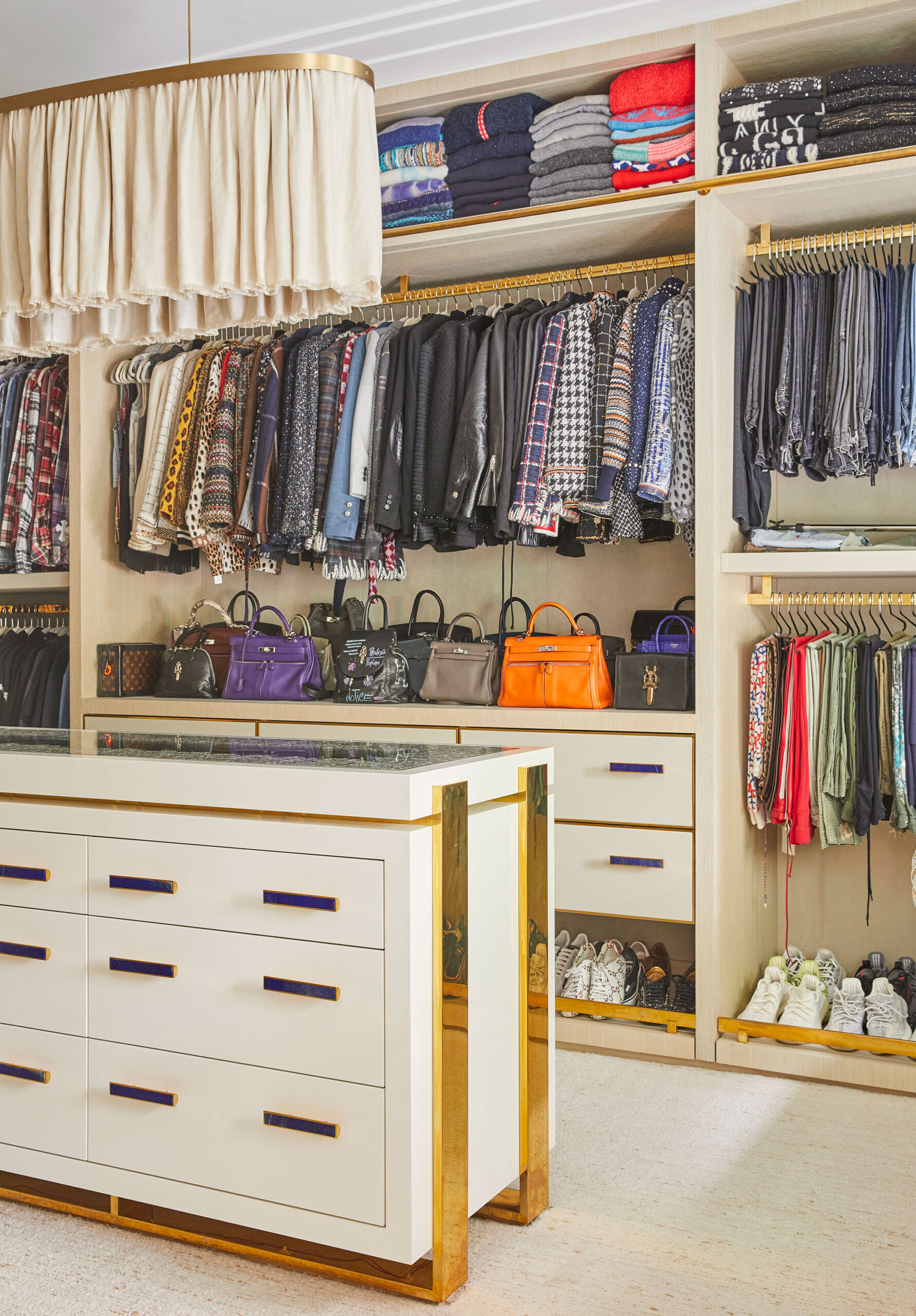 Uptown Eclectic - Pembrooke & Ives - Eclectic luxury closet with polished gold hardware. Interior...
