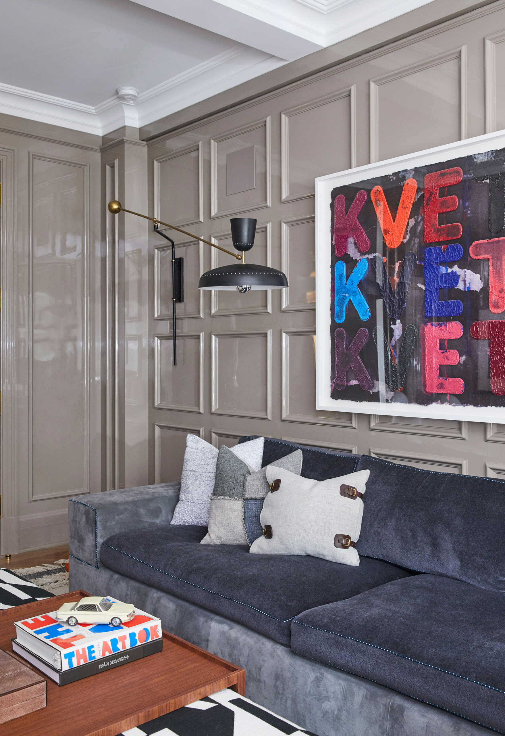Uptown Eclectic - Pembrooke & Ives - Eclectic family room with slate blue sofa, modern wall art...