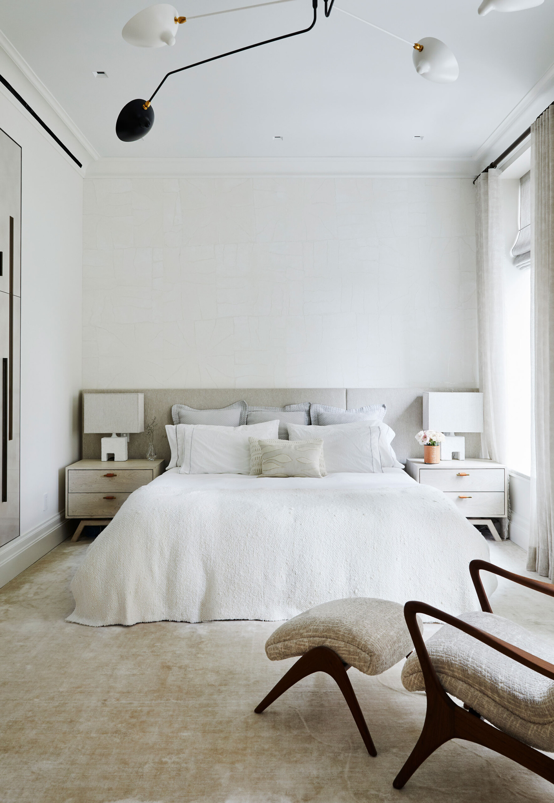 East End Avenue - White mid-century modern bedroom with neutral toned furniture and clean lines....