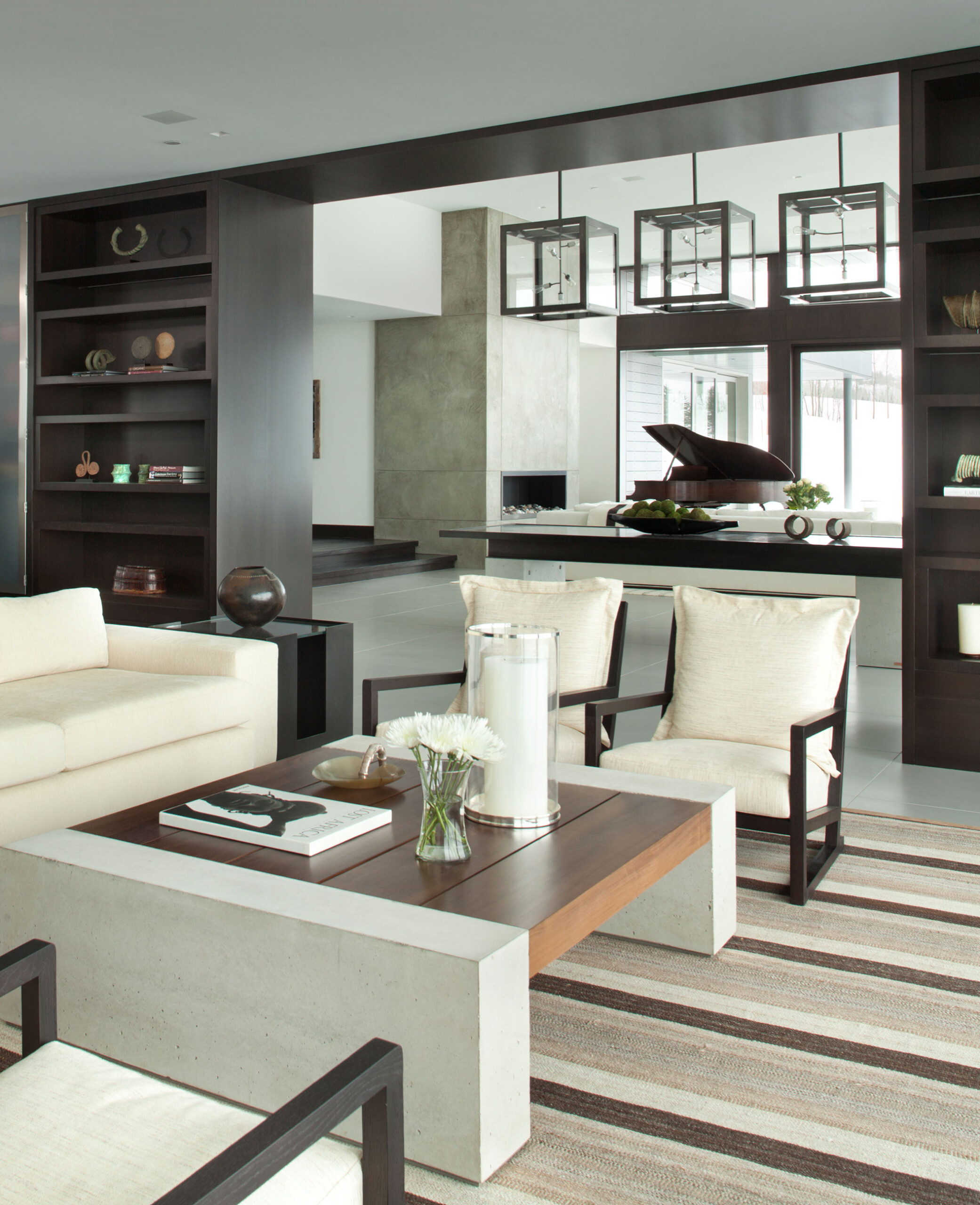Modern Mountain - Modern living room with white and wood coffee table, cream and black accent chairs....