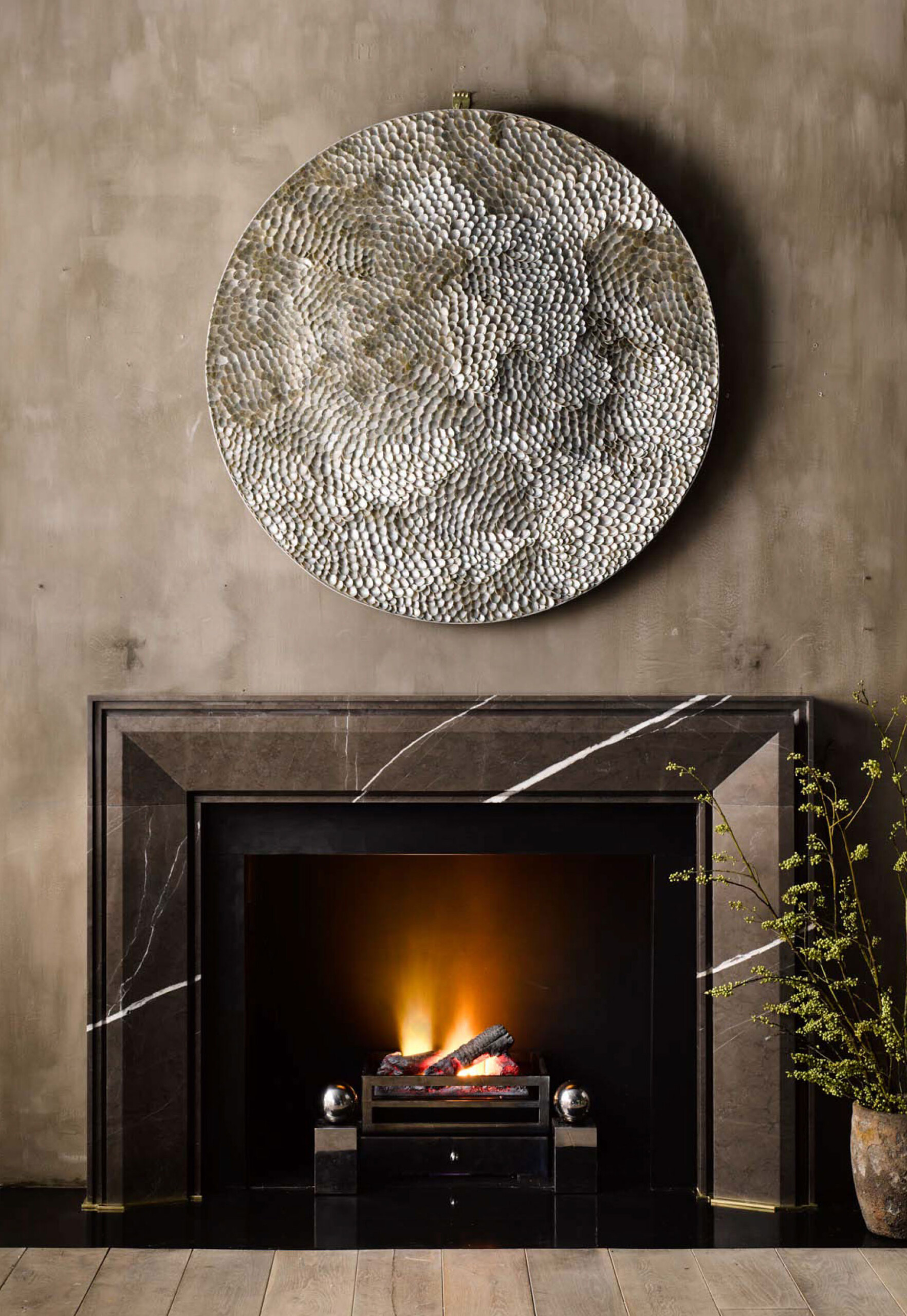 Chesneys white veined custom stone fireplace. Designed by Pembrooke & Ives.