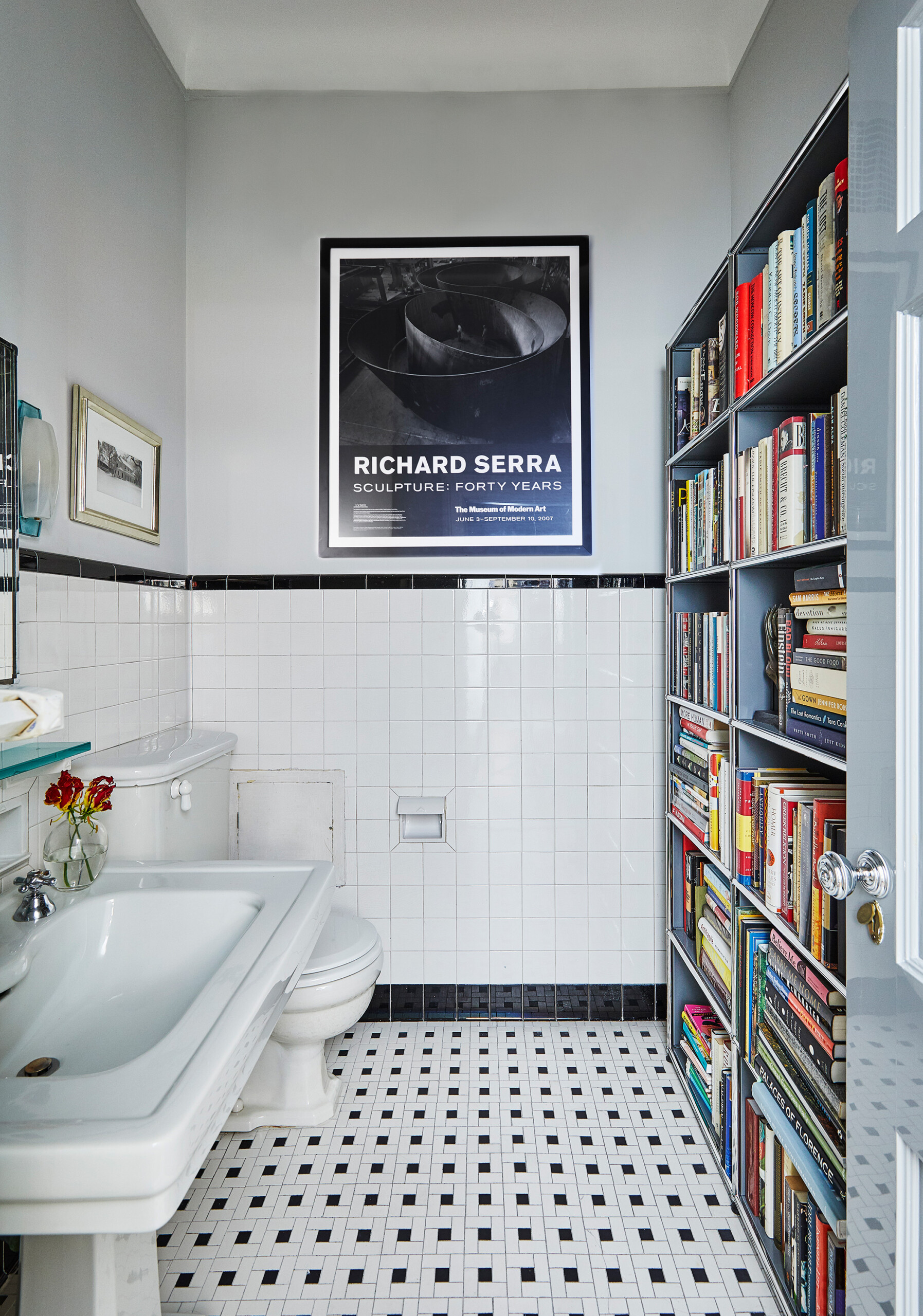 West Side Elegance - Pembrooke & Ives - West Side bathroom with white subway tile and book storage....