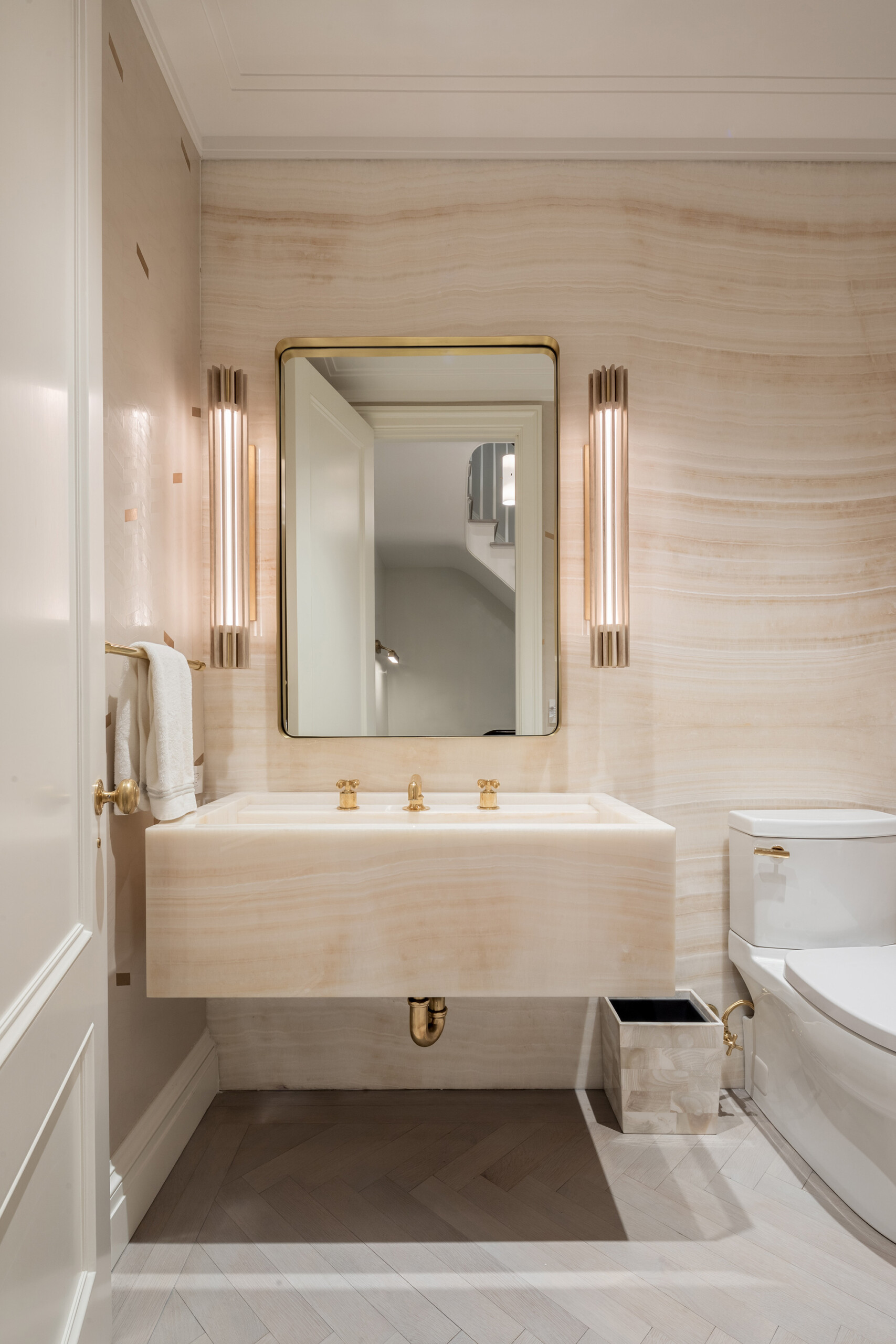 Townhouse - Bathroom in New York townhouse featuring cylindrical vanity lighting and matching stone...