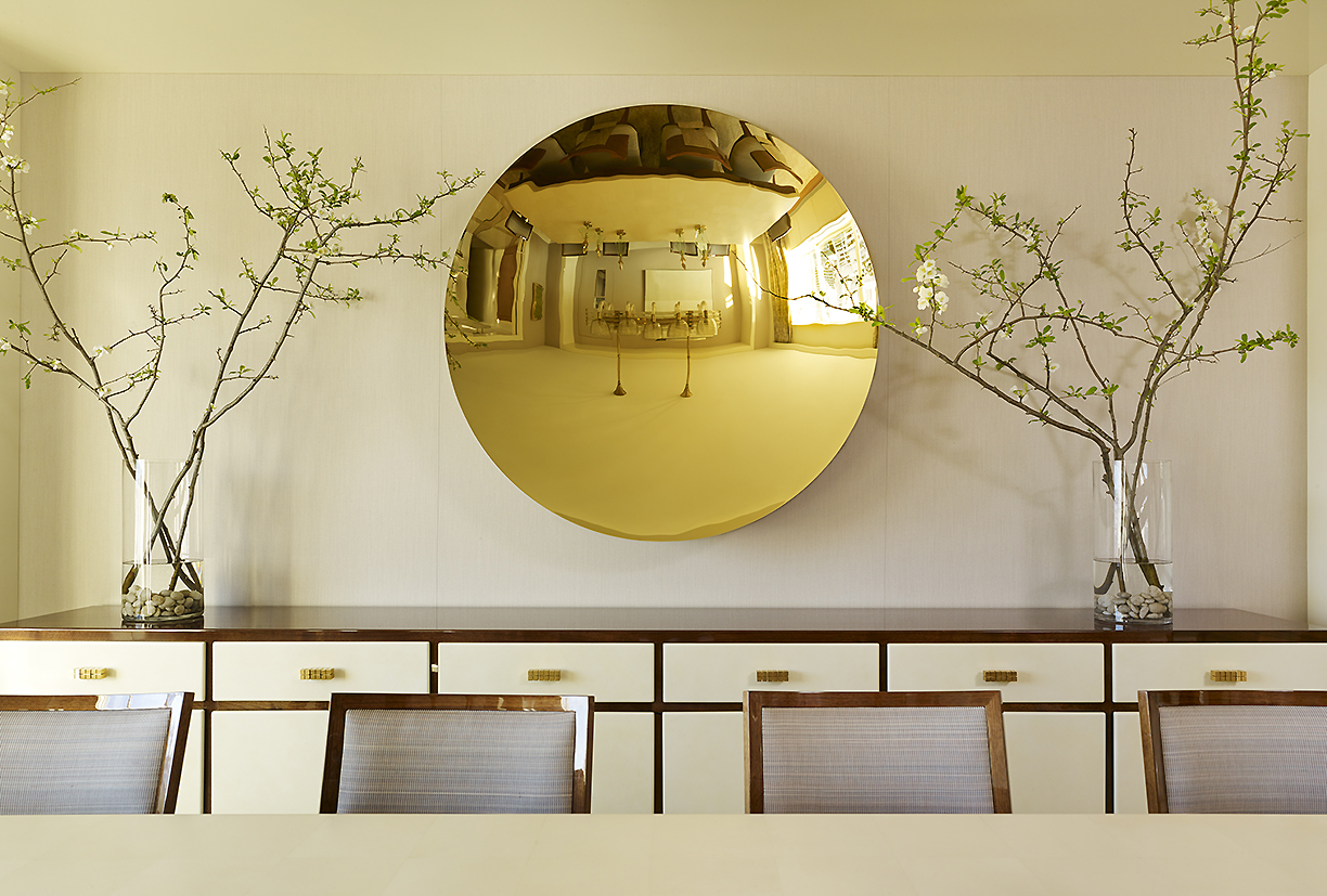 Classical Park Avenue - Round reflective gold wall decor above dining room credenza on Park Avenue....
