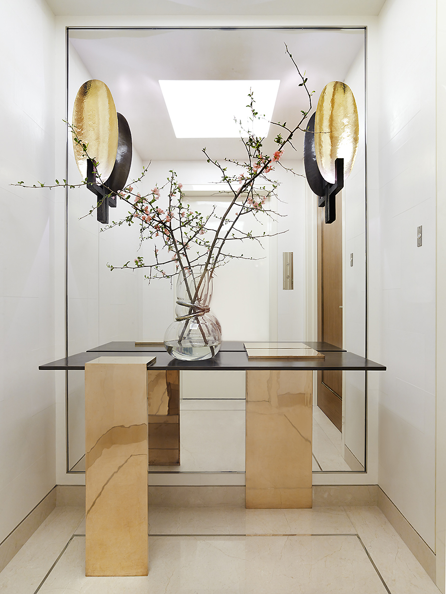 Classical Park Avenue - Park Avenue entryway featuring metallic console table and modern wall scones...