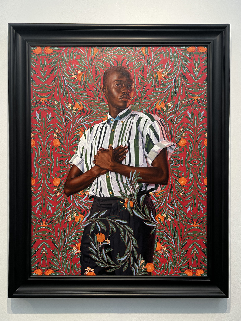 Portrait of man covered in orange leaves by Kehinde Wiley